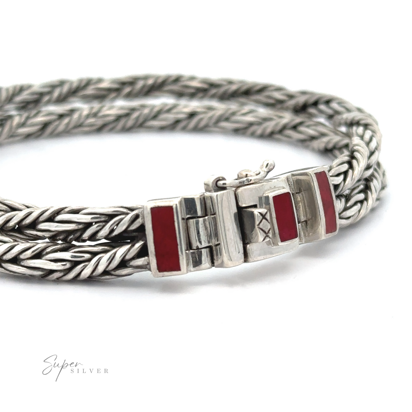 A unique Double Twisted Braided Rope Bracelet in sterling silver with a rectangular clasp featuring red accents, positioned on a white surface.