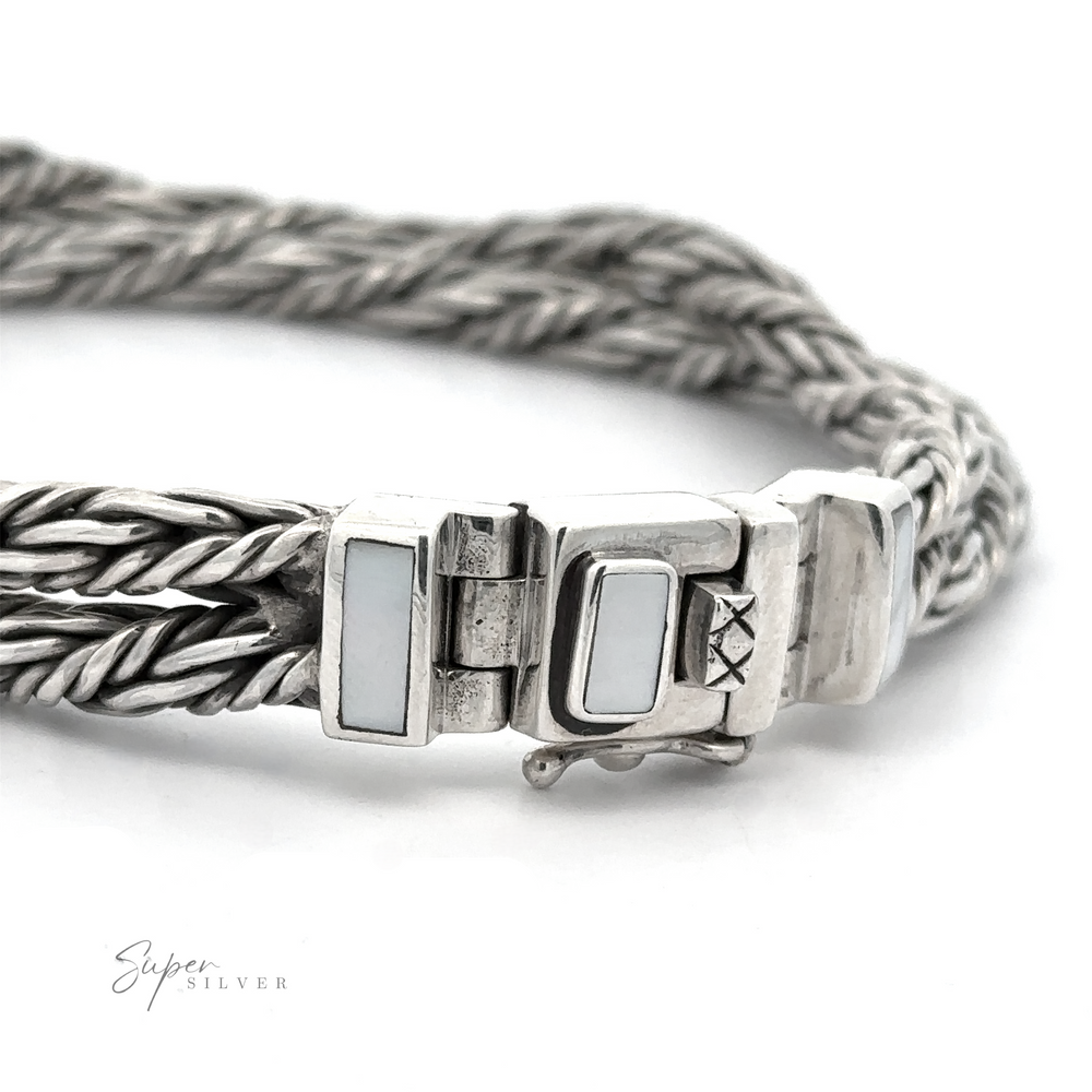 
                  
                    A close-up view of a sterling silver bracelet with a unique braided design and a clasp featuring white inlays. "Double Twisted Braided Rope Bracelet" is visible in the bottom left corner.
                  
                