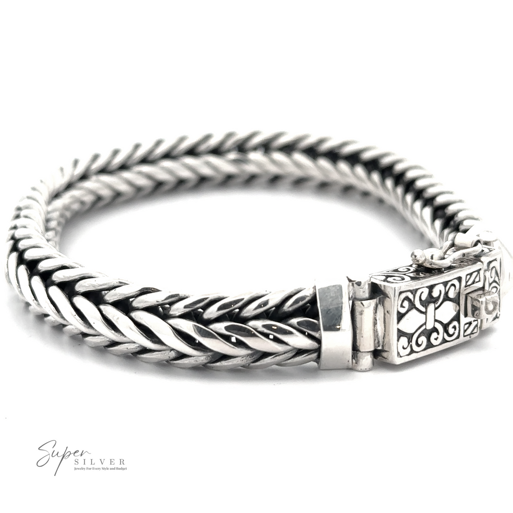 A thick, sterling silver Heavy Braided Bracelet with an ornate clasp featuring intricate designs. The men's bracelet is displayed on a white background with "Super Silver" written in the corner.