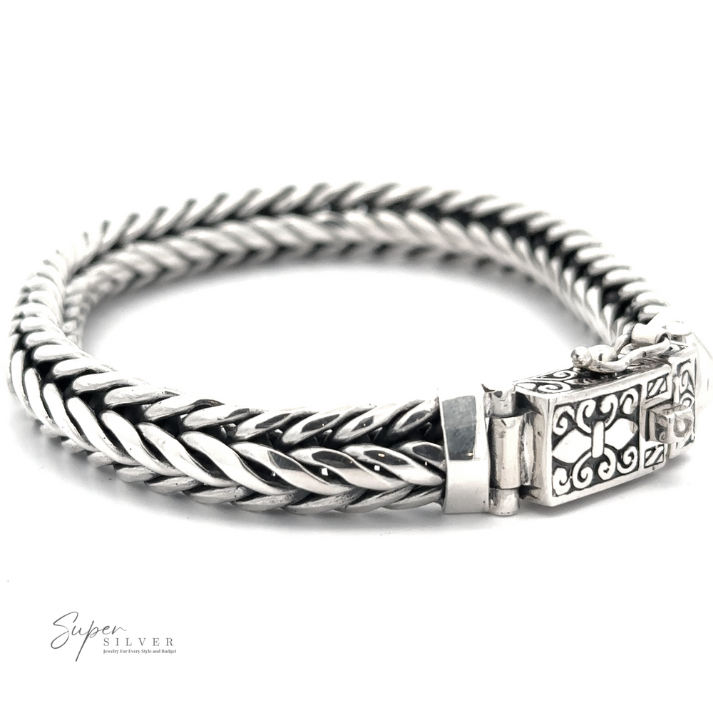 A thick, sterling silver Heavy Braided Bracelet with an ornate clasp featuring intricate designs. The men's bracelet is displayed on a white background with 