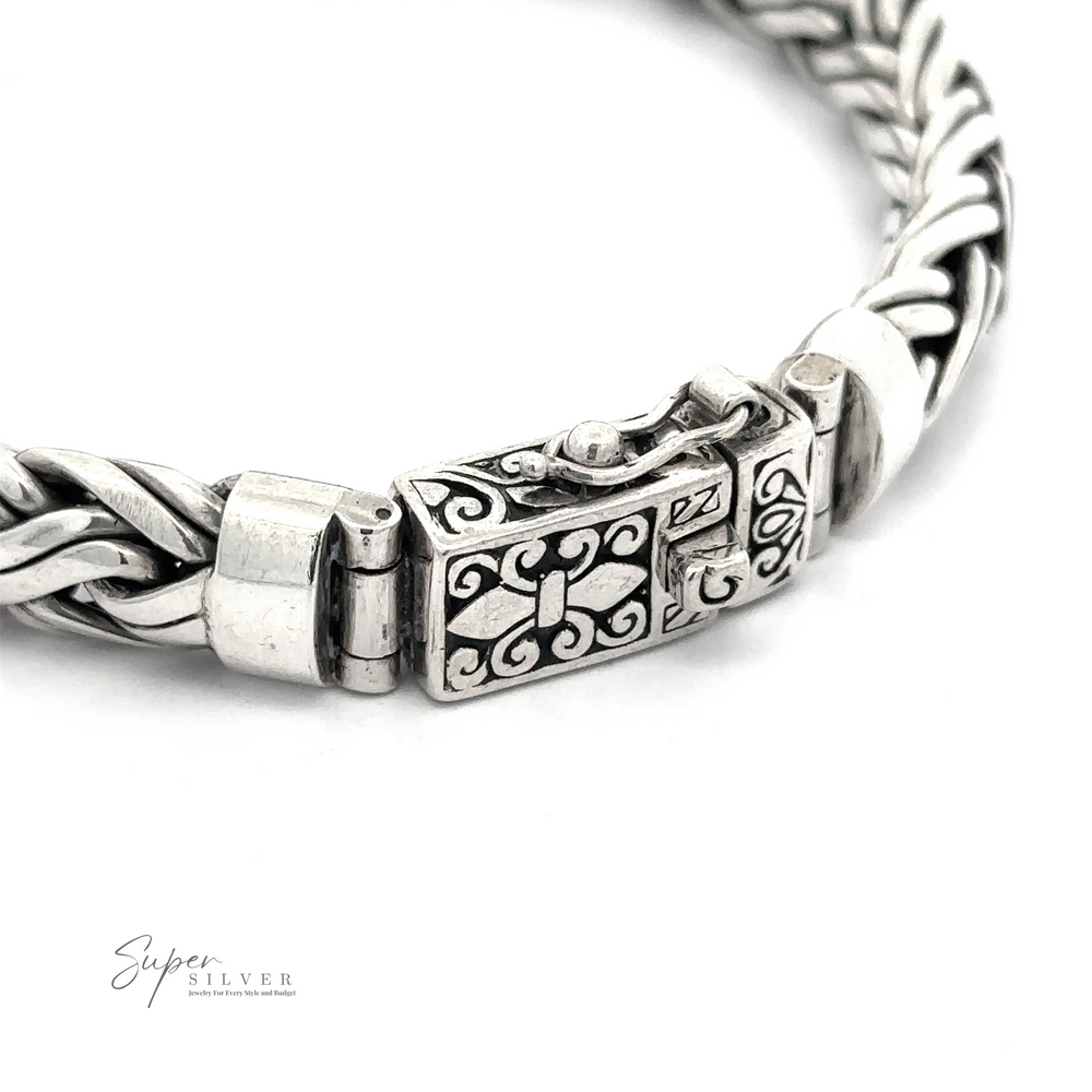 
                  
                    Close-up of a Heavy Double Strand Braided Bracelet with an intricate woven design and an ornamental clasp, crafted from .925 Sterling Silver, featuring the logo “Super Silver” in the bottom left corner.
                  
                