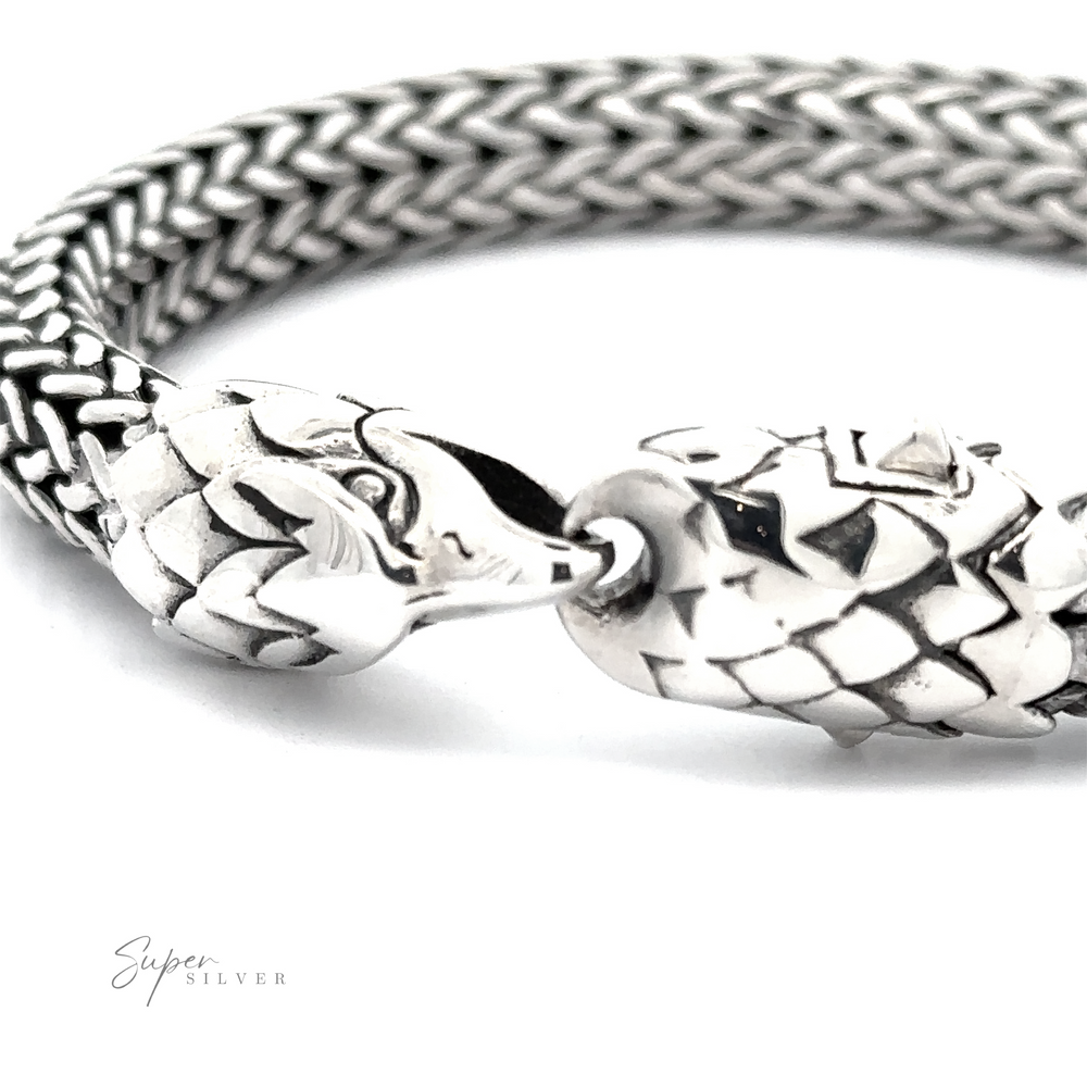 Close-up of a Heavy Braided Bracelet with Eagle Clasp, crafted from .925 Sterling Silver, with intricately detailed eagle head clasps on both ends, connected by a woven chain. The brand name 