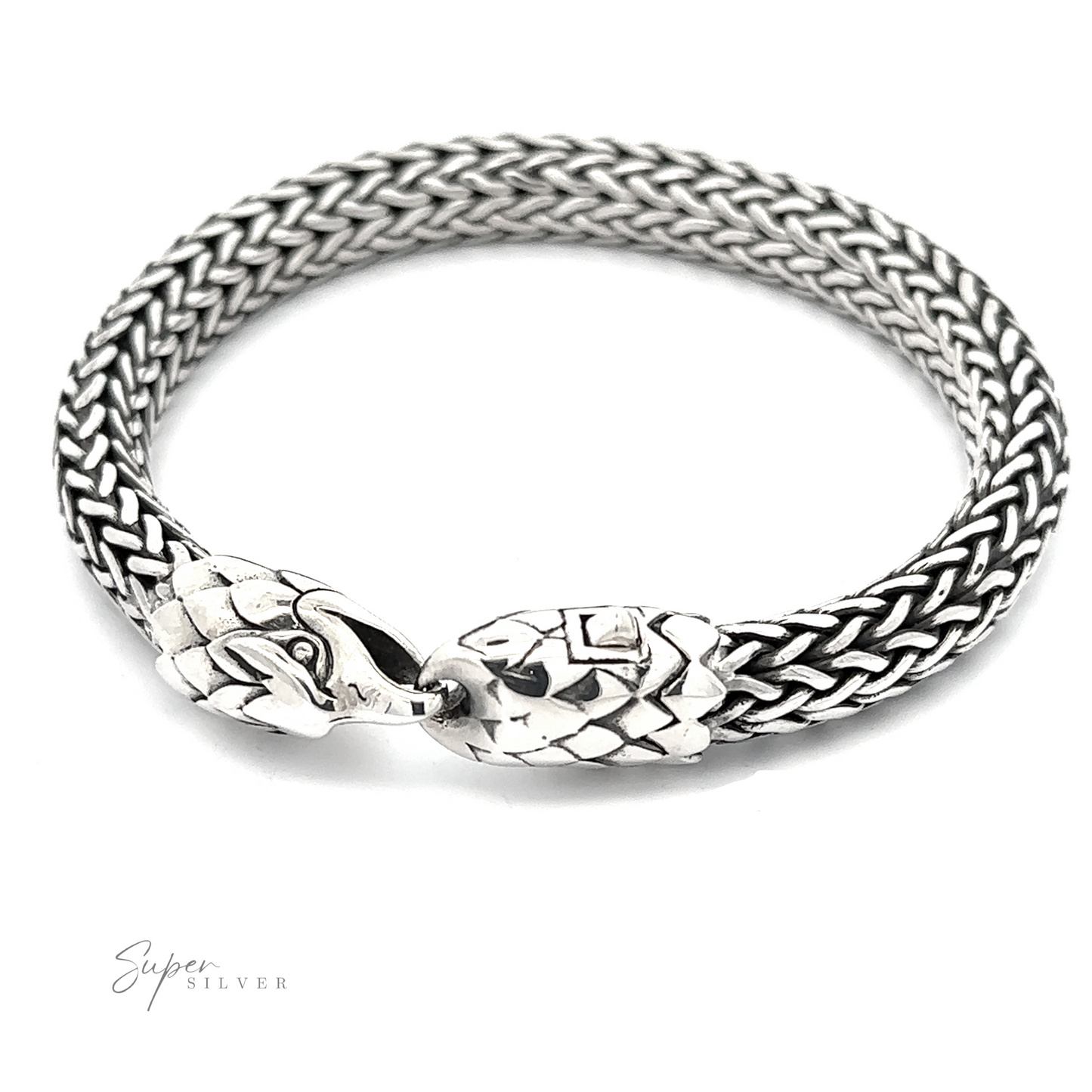 A bold bracelet crafted from .925 Sterling Silver, this piece features a woven design with two intricately designed eagle heads facing each other at the clasp.
