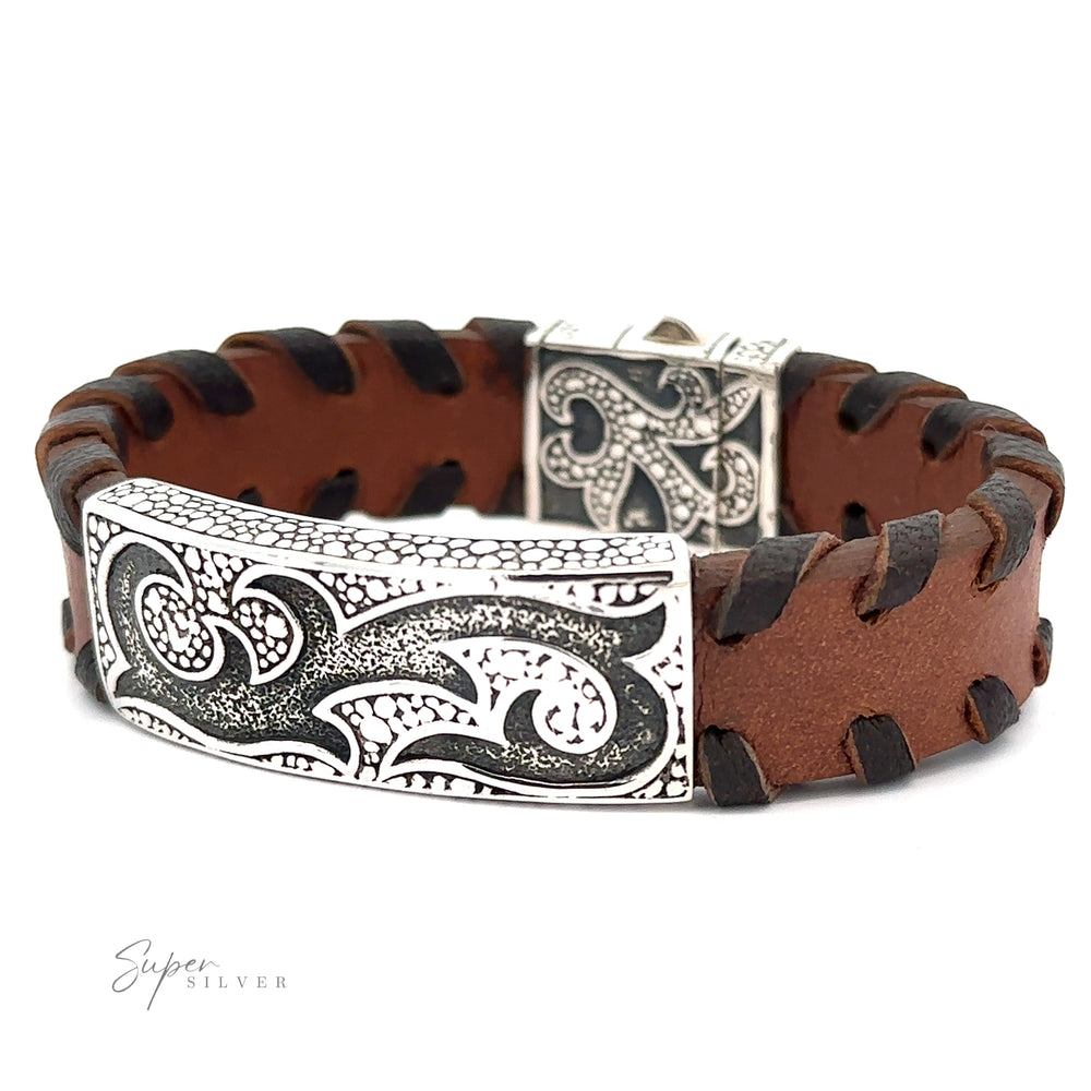 
                  
                    A brown leather bracelet with black lacing and a decorative silver clasp and plate featuring intricate swirl designs. "Tribal Leather Bracelet" is written in the bottom left corner, accentuating the tribal silver center.
                  
                