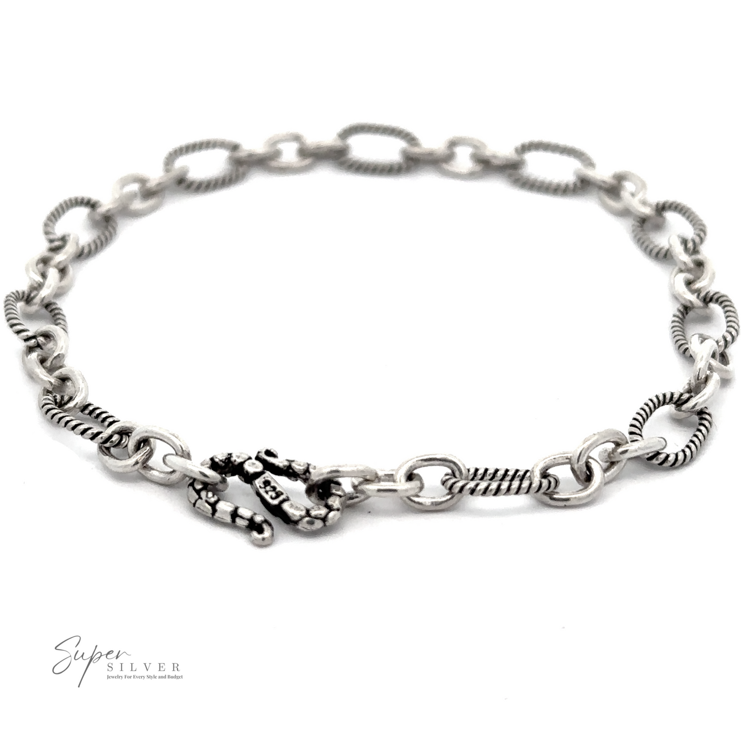 A Lasso and Rolo Bracelet featuring a mix of textured and smooth chain links with a decorative clasp, inspired by Balinese artistry.