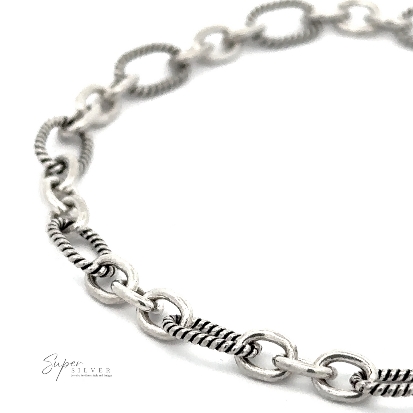 
                  
                    Close-up image of a silver chain bracelet with alternating solid and textured links on a white background. The logo "Super Silver" appears in the bottom left corner, highlighting this Lasso and Rolo Bracelet inspired by Balinese artistry.
                  
                