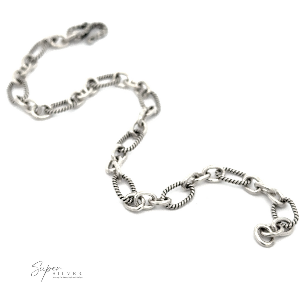 
                  
                    A Lasso and Rolo Bracelet with a mix of twisted and smooth links, embodying Balinese artistry, rests elegantly on a white background. The logo "Super Silver: Jewelry & The Best Silver" is in the bottom left corner.
                  
                