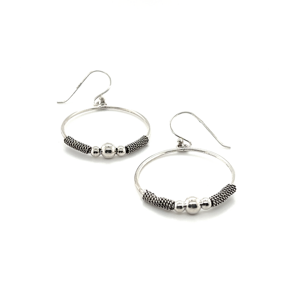 
                  
                    A pair of Super Silver Bali Style Circle Drop Earrings with black beads, in a bali style drop design that has an approximate length.
                  
                