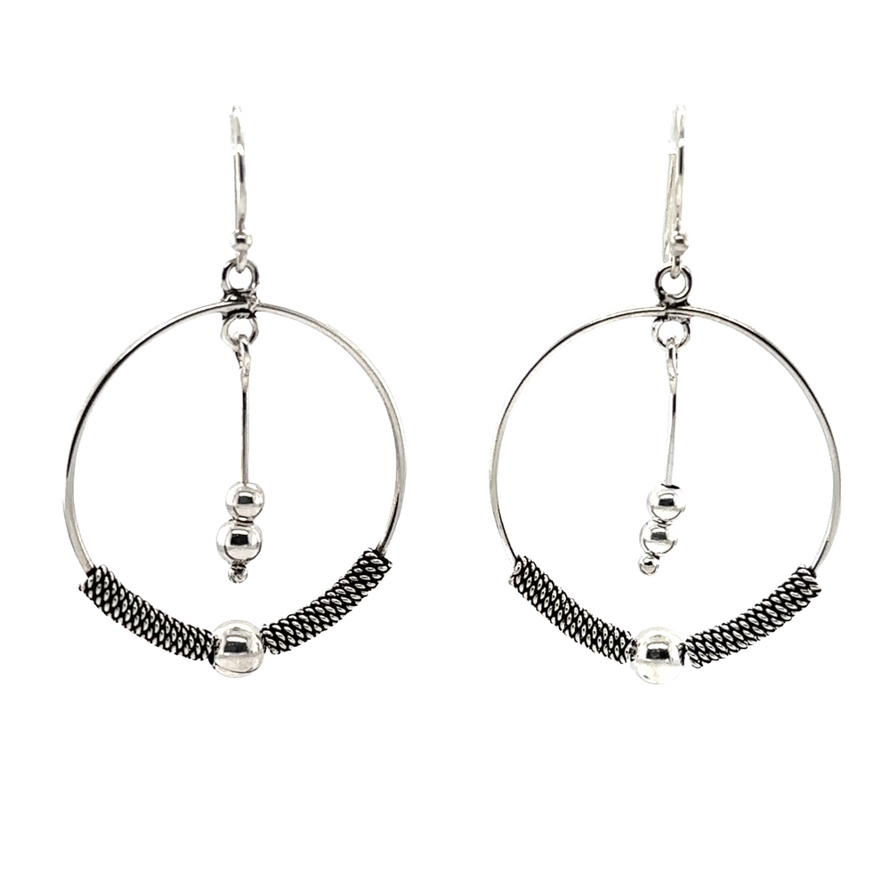 
                  
                    A pair of Bali Style Circle Drop Earrings with Tassel from Super Silver.
                  
                