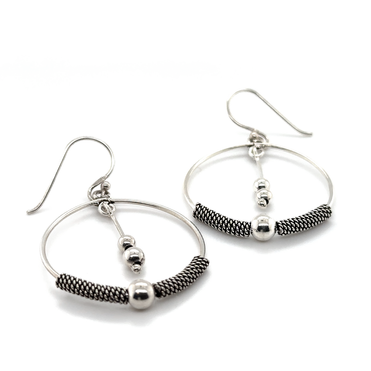 
                  
                    Handcrafted Super Silver Bali Style Circle Drop Earrings with Tassel accented by black beads.
                  
                