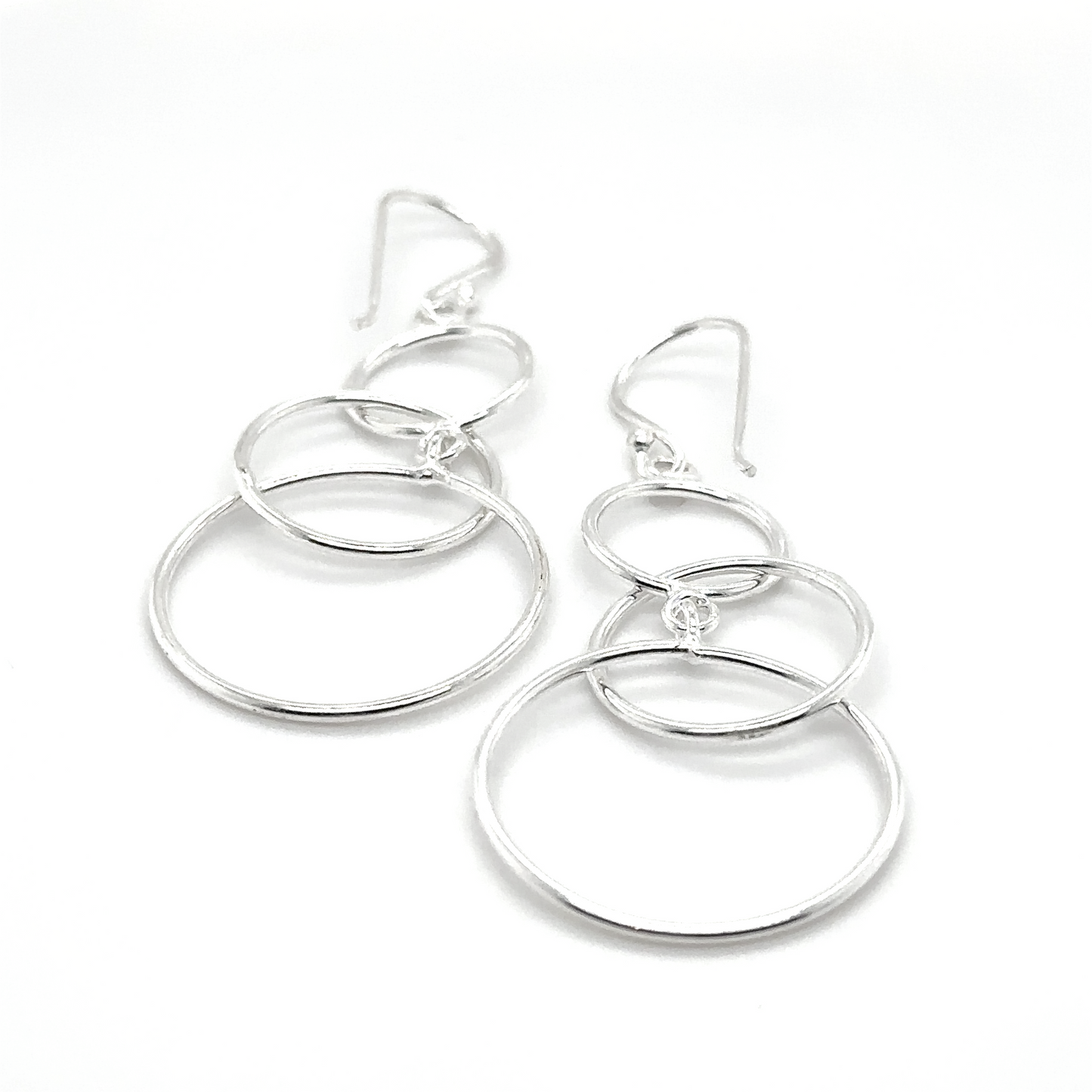 A comfortable to wear pair of Super Silver Interlocked Circles Earrings on a white background.