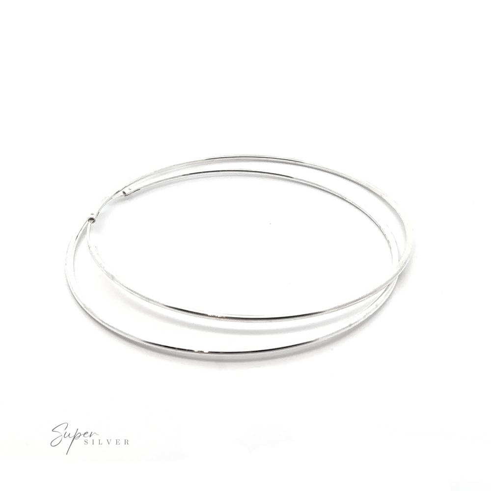 
                  
                    Versatile 2mm Infinity Hoops adding minimalist flair to any outfit, featured on a white background.
                  
                