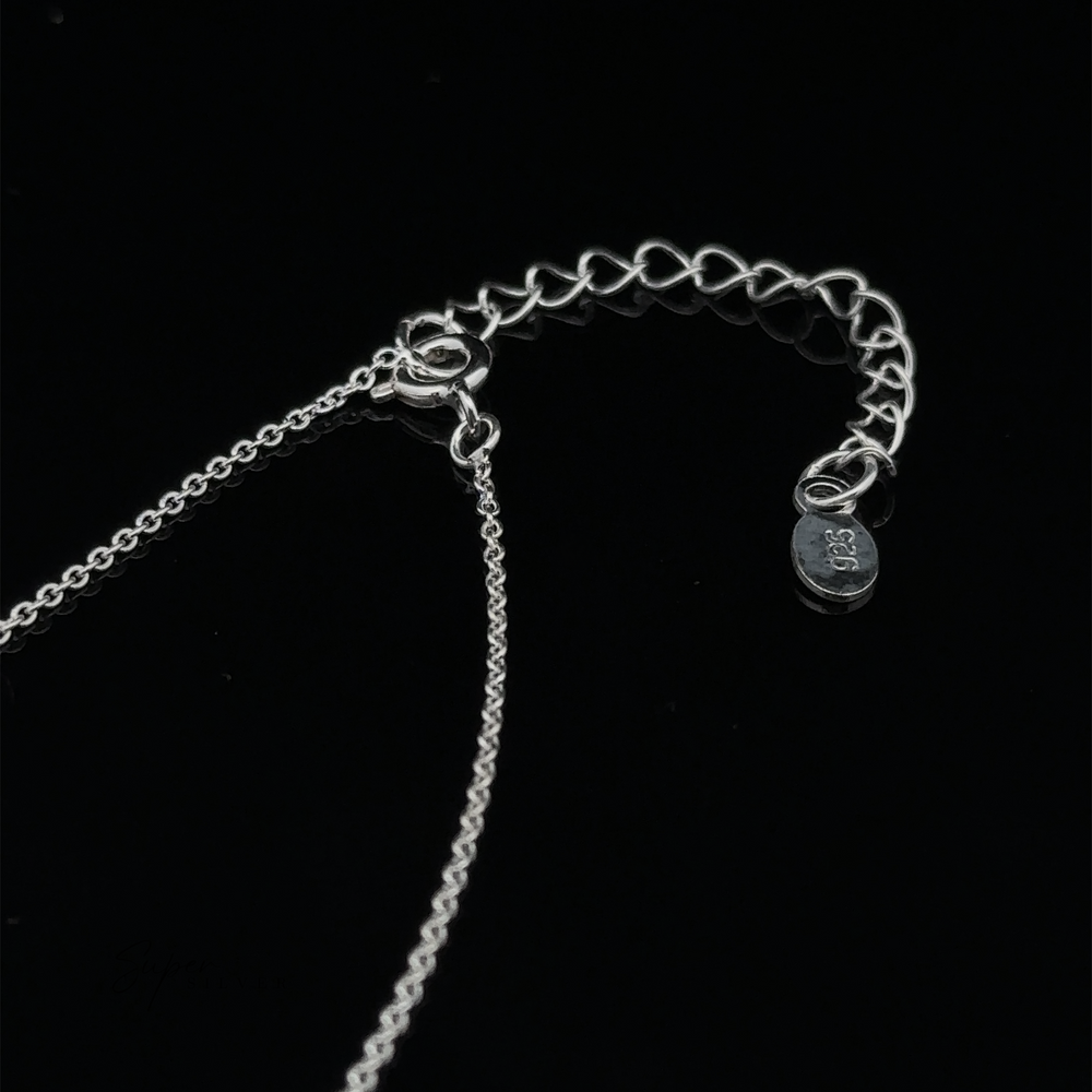 
                  
                    Double Circle Necklace with a chain and clasp set against a black background. The chain includes an extender and a small tag inscribed with ".925 Sterling Silver." This elegant piece symbolizes an eternal bond, perfect for any occasion.
                  
                