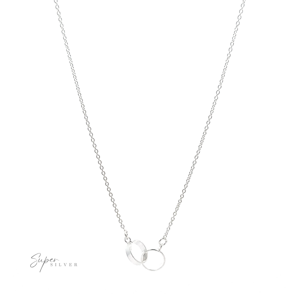 
                  
                    A Double Circle Necklace with a delicate chain features two interlocking rings as a pendant, symbolizing an eternal bond. The double-circle necklace is thin and minimalistic, perfect for everyday wear. The logo "Super Silver" appears in the bottom left corner.
                  
                