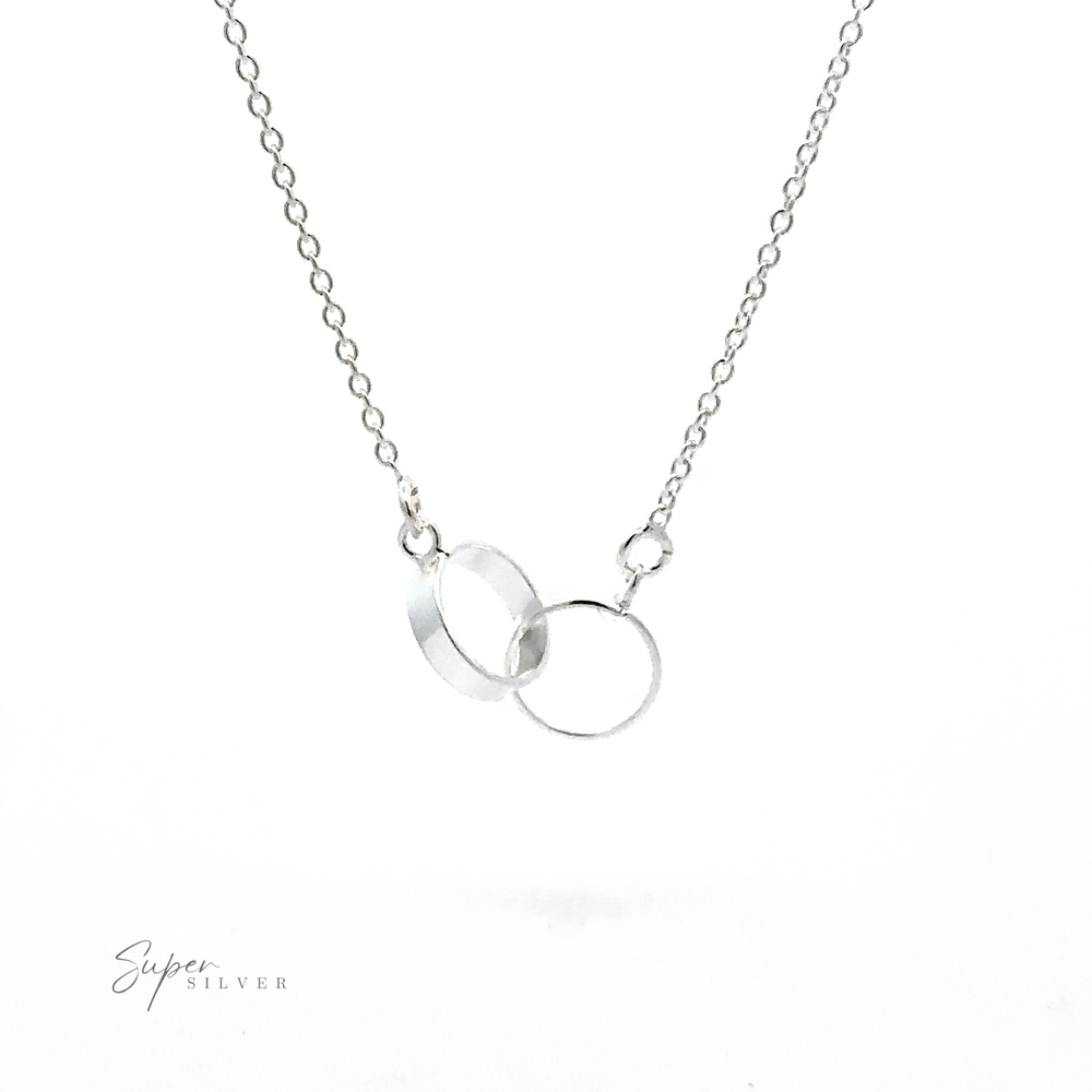 A Double Circle Necklace featuring two delicate interlocking rings on a fine chain, symbolizing an eternal bond. The image includes the logo 