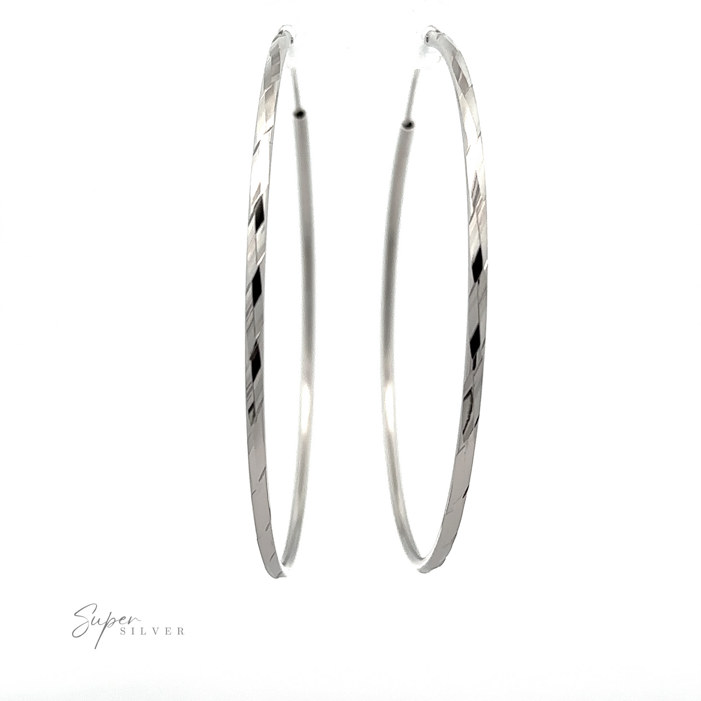 A pair of Brilliant 60mm Rhodium Finish Faceted Hoops, displayed against a white background.