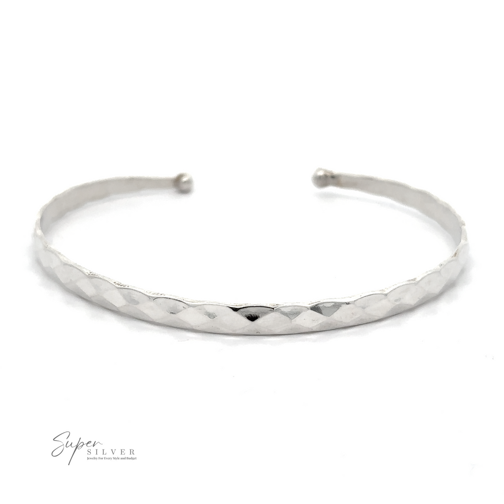 
                  
                    A Stackable Hammered Cuff bracelet with a textured, diamond pattern surface is shown against a white background. The text "Super Silver" appears in the lower-left corner, highlighting its timeless look.
                  
                