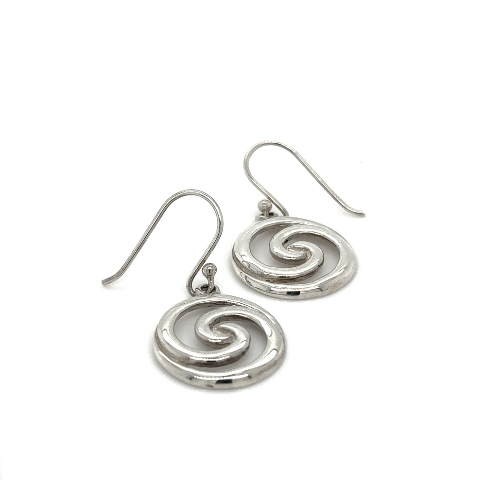 A pair of sterling silver Circular Swirl Earrings with a spiral design featuring silver circle swirls.