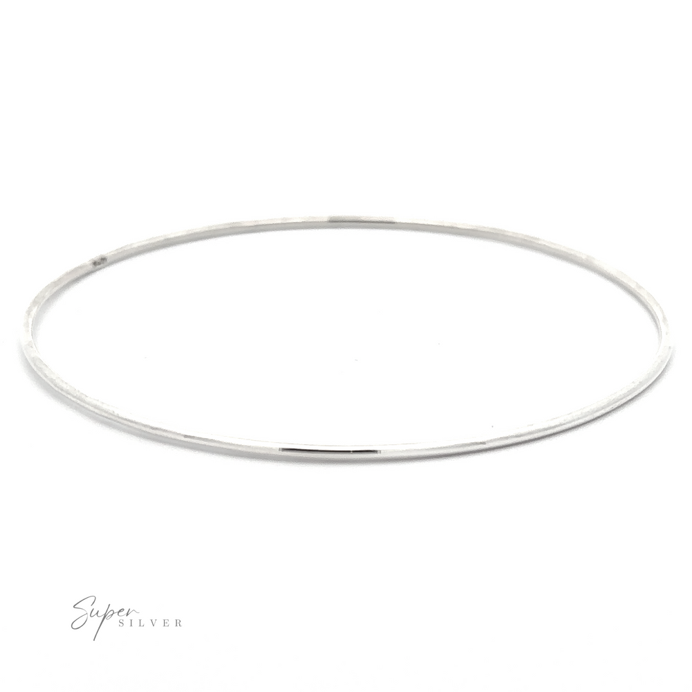 
                  
                    A thin, Plain Bangle with a smooth, polished finish is displayed on a white background. The logo "Super Silver" is visible in the lower left corner, emphasizing its appeal as a versatile accessory.
                  
                