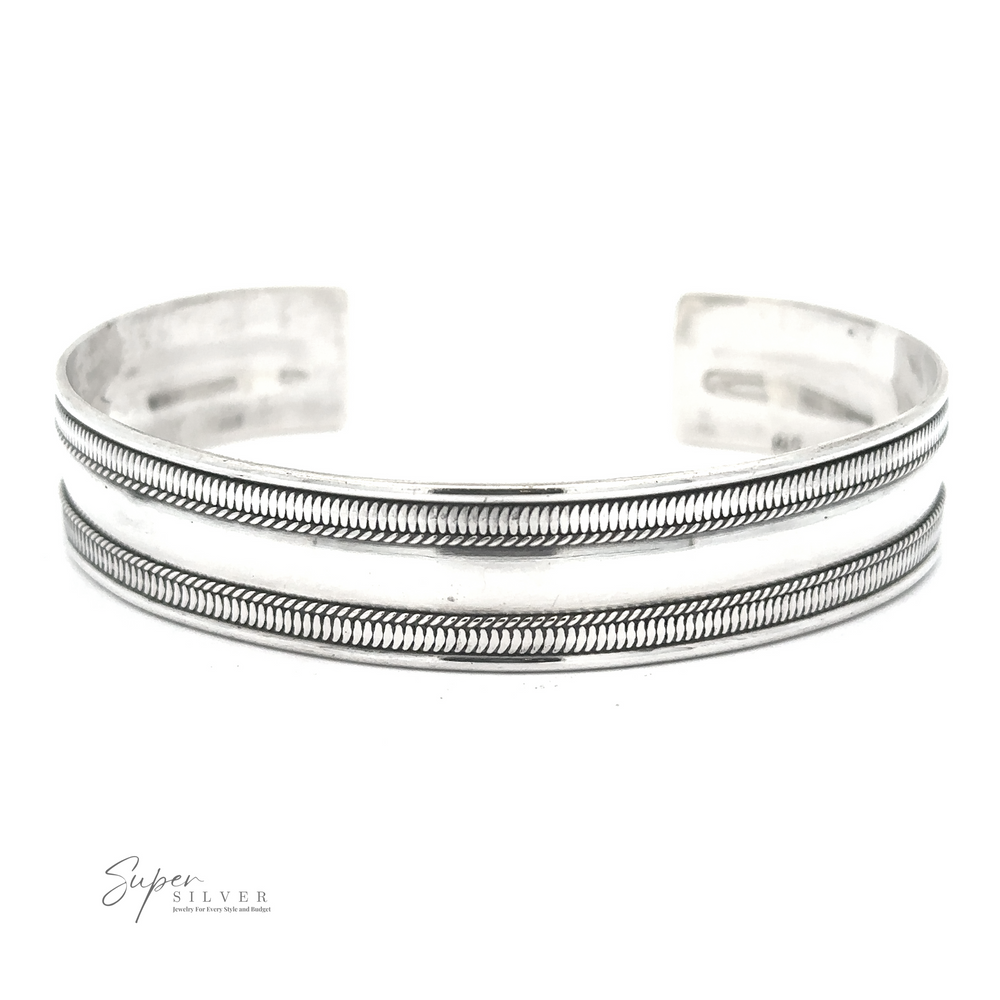 
                  
                    A Silver Cuff Bracelet featuring two engraved parallel bands. The inscription "Super Silver" is visible in the corner. This adjustable size accessory ensures the perfect fit for any wrist.
                  
                