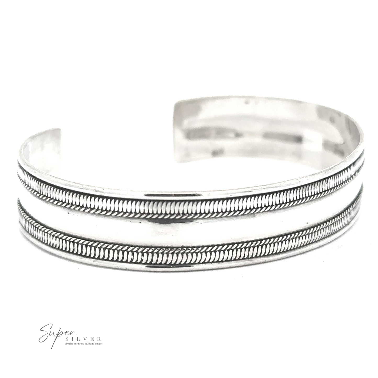 
                  
                    A Silver Cuff Bracelet with two parallel etched lines and a subtle pattern between them, labeled "Super Silver" in the bottom left corner. This adjustable size piece combines elegance with versatility.
                  
                