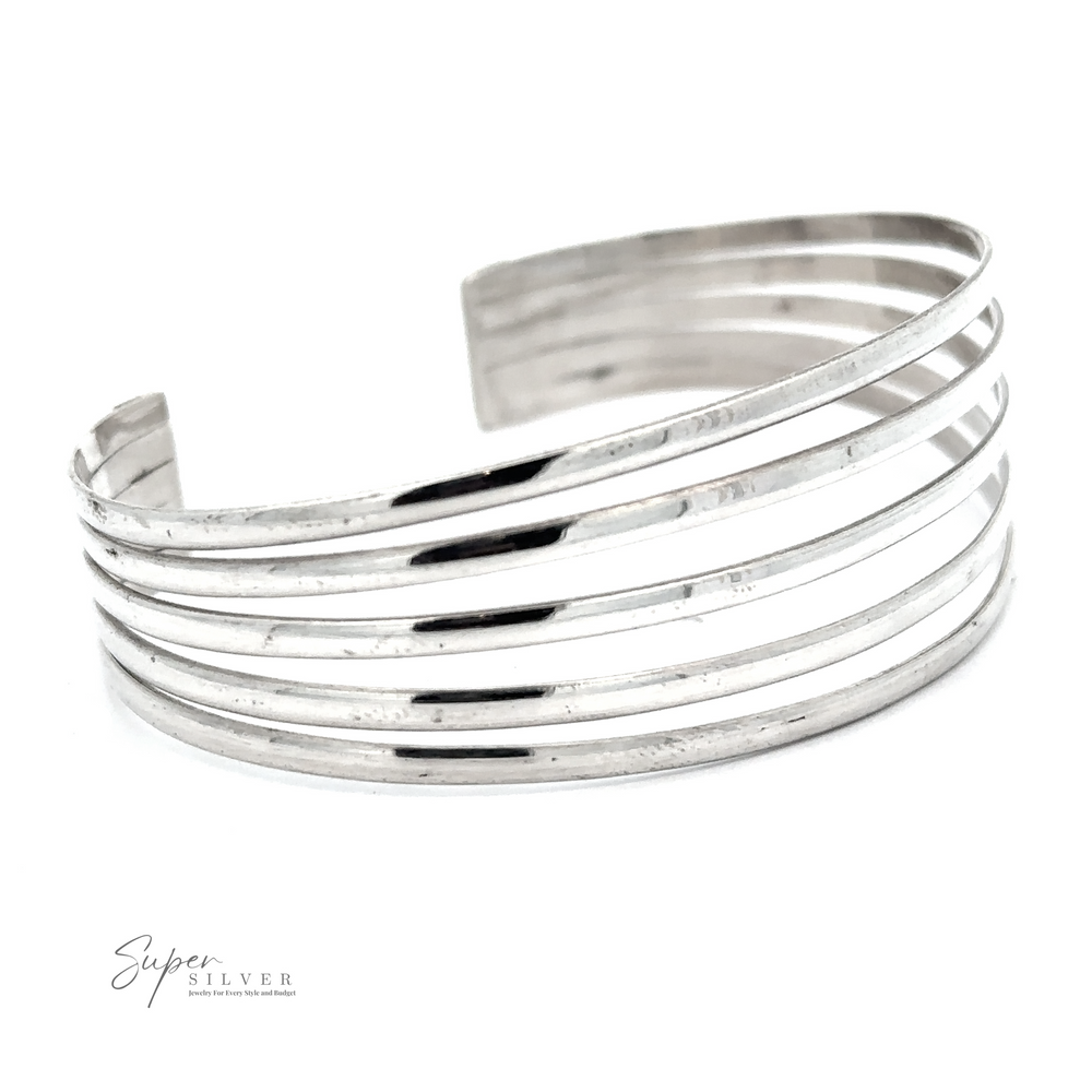 A Simple Cuff with Open Design with multiple horizontal bands, displayed on a white background. The words "Super Silver" are visible in the lower-left corner, capturing its modern chic essence.