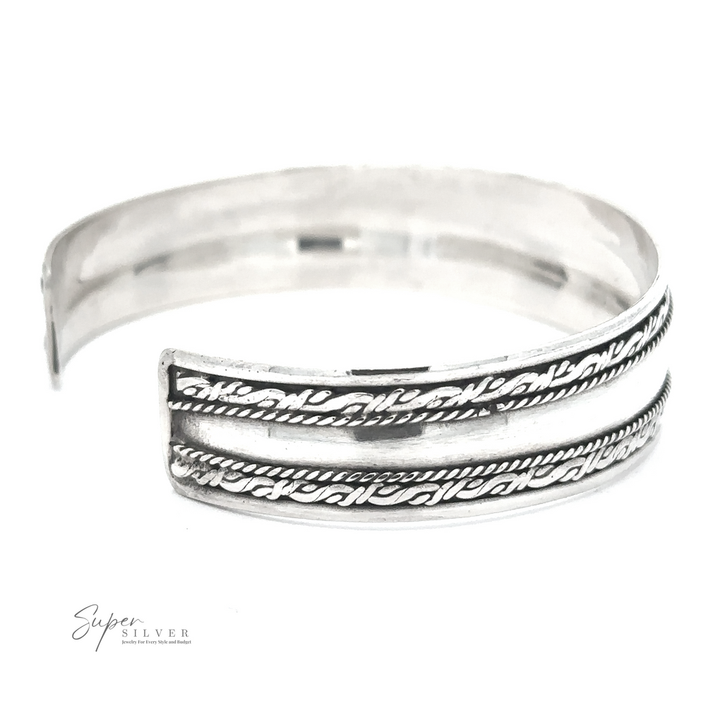 A Silver Domed Cuff with Rope Pattern in sterling silver with intricate patterns and an open design is displayed against a white background. The bracelet features an elegant oxidized rope border, and the "Super Silver" logo is visible in the bottom left corner.