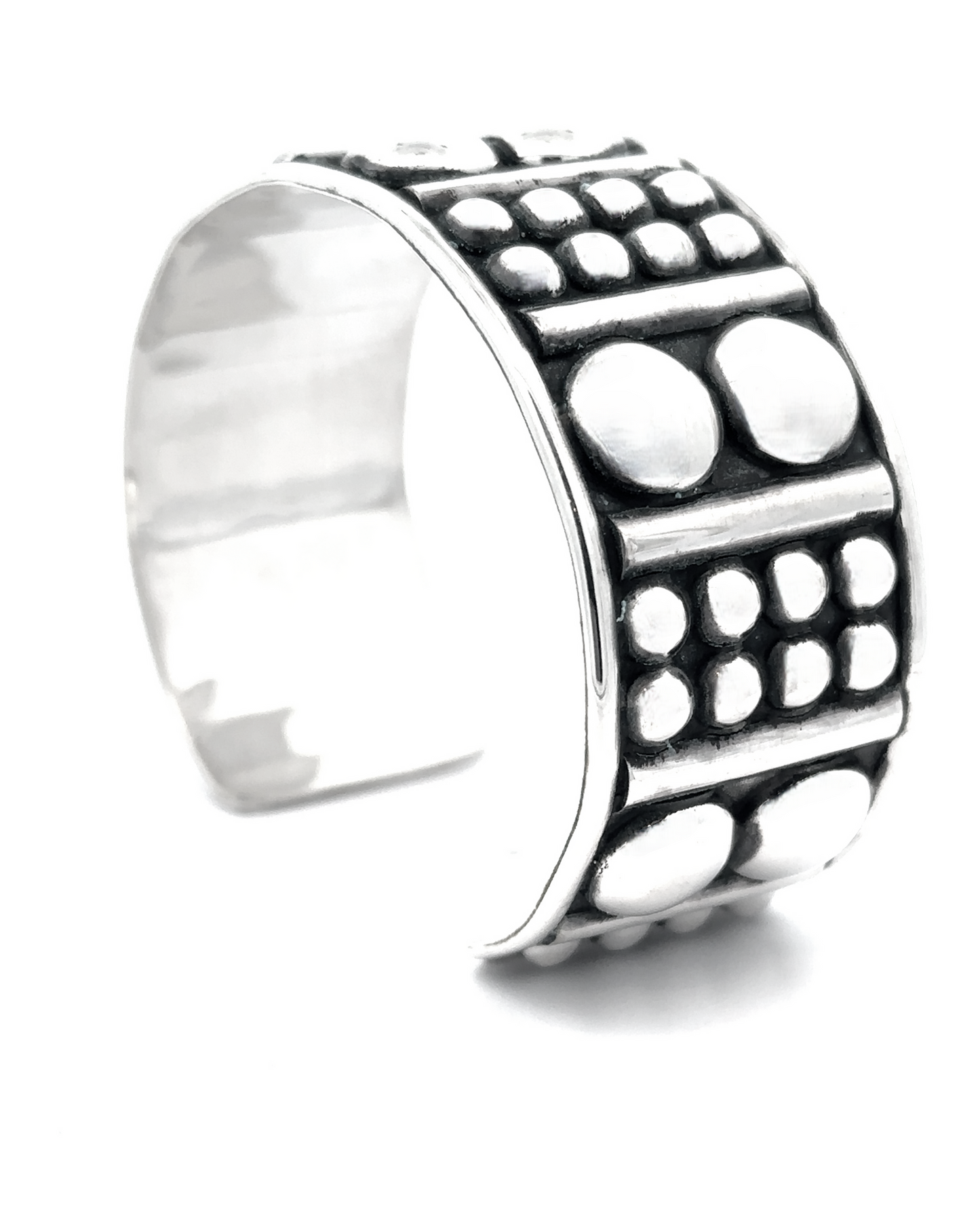 Sterling silver cuff with a wide band featuring an edgy design of raised circles and dots, known as the Bold Ball Patterned Cuff.