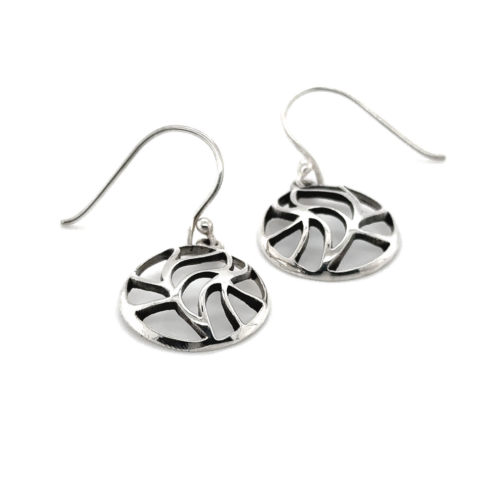 A pair of Super Silver Circle Earrings with Leaf Cutouts and a freestyle abstract design.