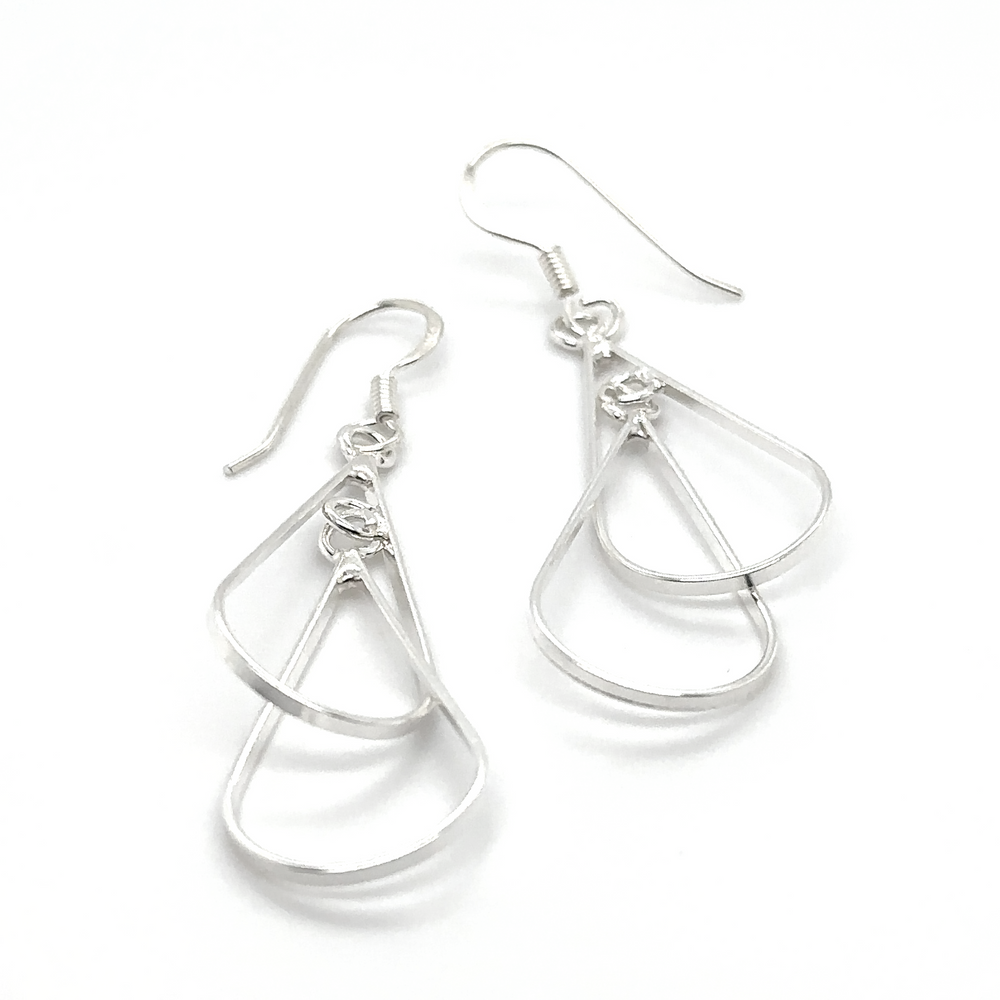 A lightweight pair of Double Wire Teardrop Earrings from Super Silver, with a modern design, swinging gracefully like teardrops on a white background.