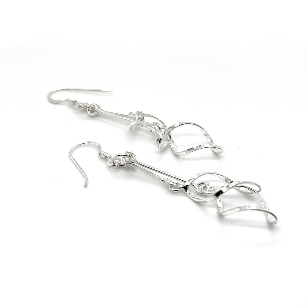 A pair of Delicate Twisted Freeform Earrings by Super Silver on a white background.