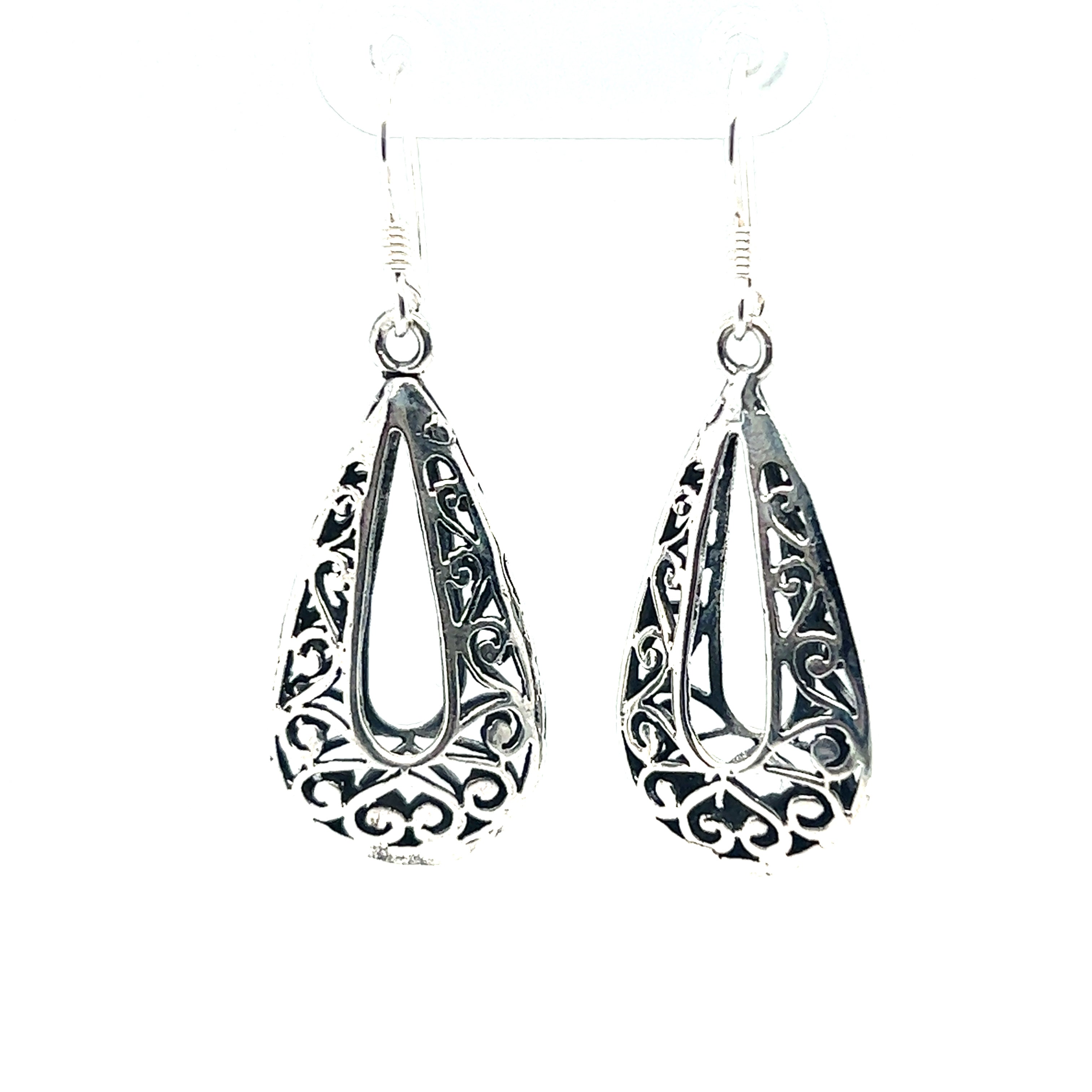 A pair of Super Silver Filigree Teardrop Earrings with Open Center, adding a bohemian flair to any outfit.