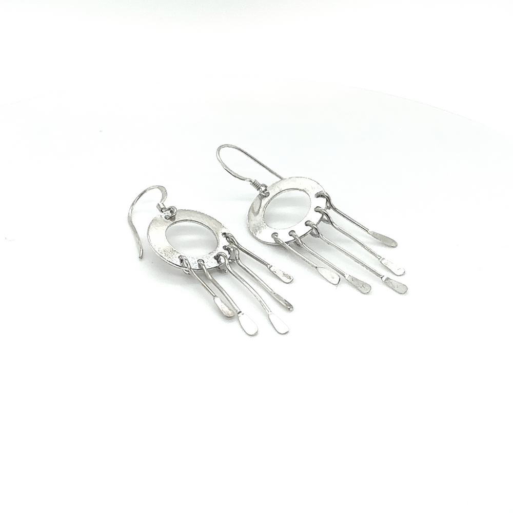 
                  
                    A pair of Super Silver Circle Tassel Earrings on a white background.
                  
                