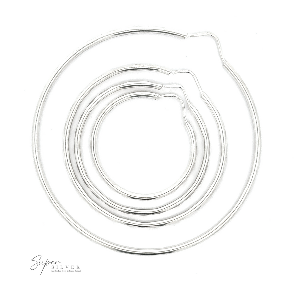 
                  
                    1.5mm Faceted Silver Infinity Hoops in various sizes laid out in a circular arrangement on a white background, showcasing a simple and elegant design with a rhodium finish.
                  
                