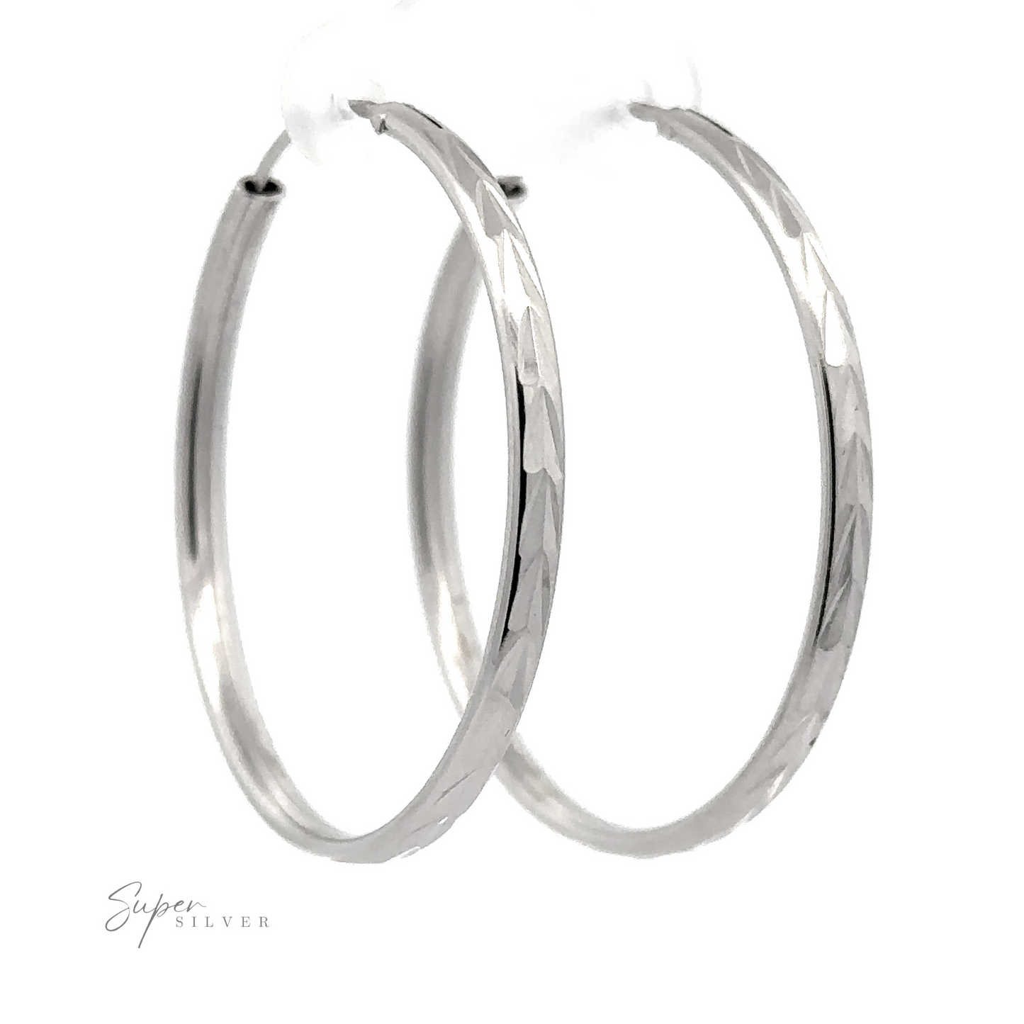 
                  
                    A pair of 3mm Chevron Faceted Hoops with a faceted design, isolated on a white background, with a signature in the corner that reads "super silver.
                  
                