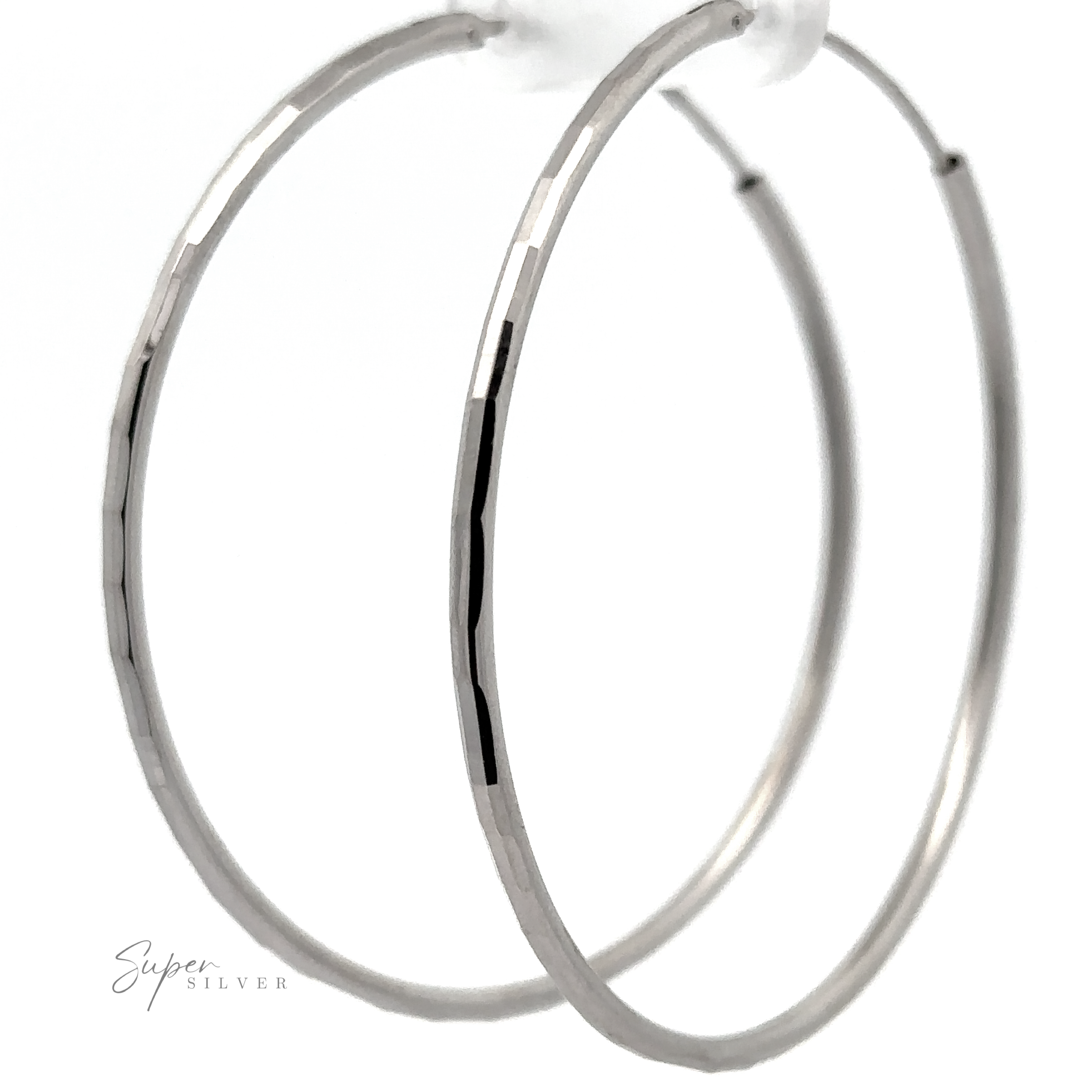 A close-up of two 2mm Diamond Cut Hoop Earrings with a rhodium finish, displayed against a white background.