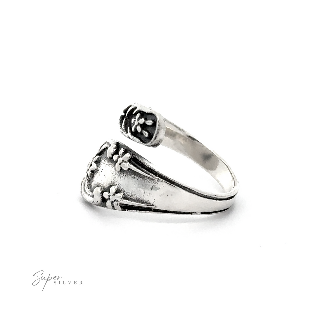 
                  
                    An adjustable Spoon Design Ring with a flower on it.
                  
                