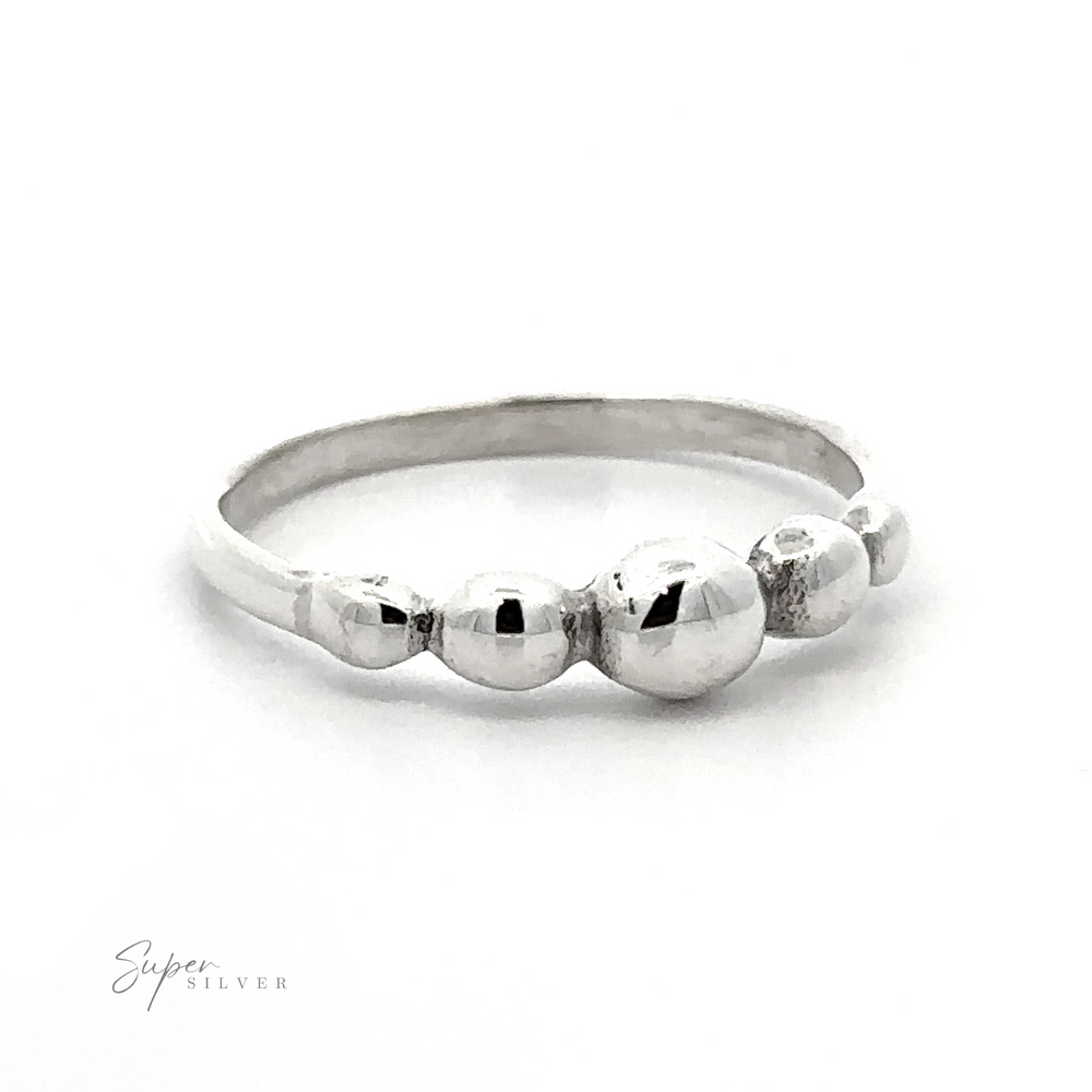 A Dainty Graduated Silver Ball Ring with a tactile experience featuring three balls on it.