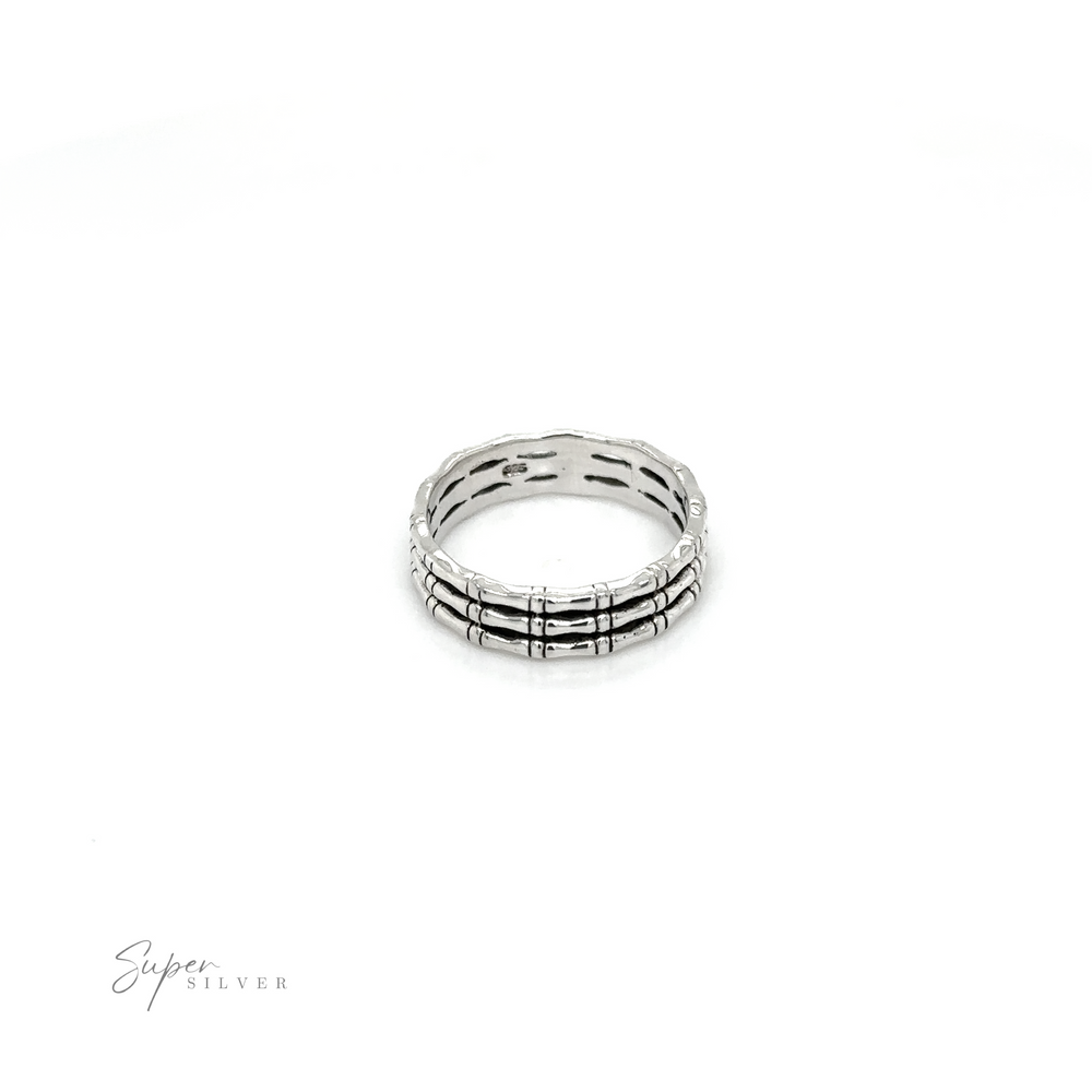 
                  
                    A Triple Bamboo Band ring with black and white stripes on a white background, from Super Silver, in a minimalist style.
                  
                