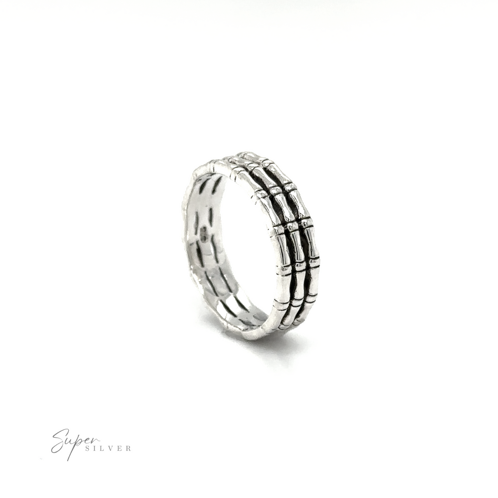 
                  
                    A minimalist style Triple Bamboo Band Ring with black and white stripes on a white background made by Super Silver.
                  
                