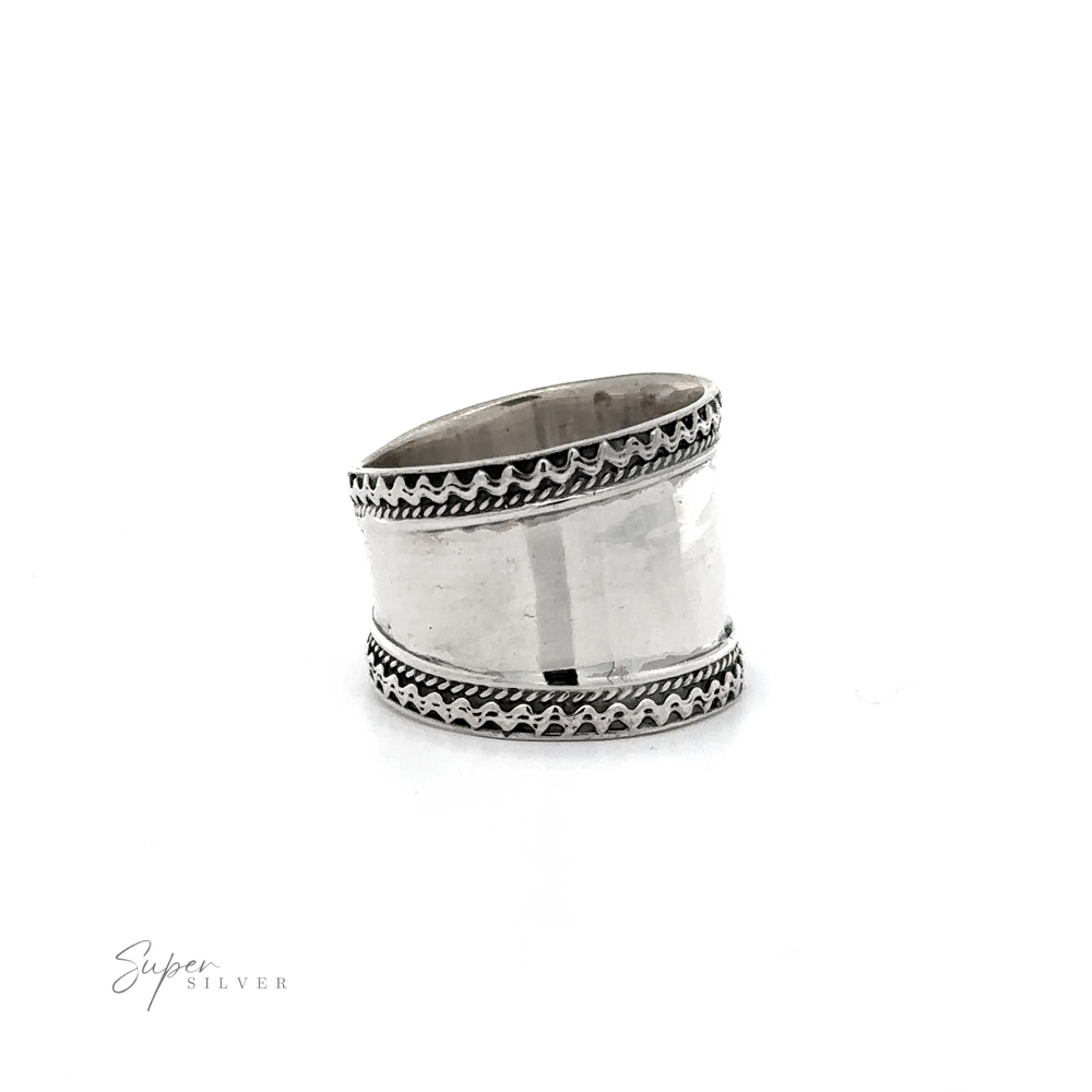 
                  
                    A Wide Silver Band with Etched Border ring with black and white rope pattern designs.
                  
                