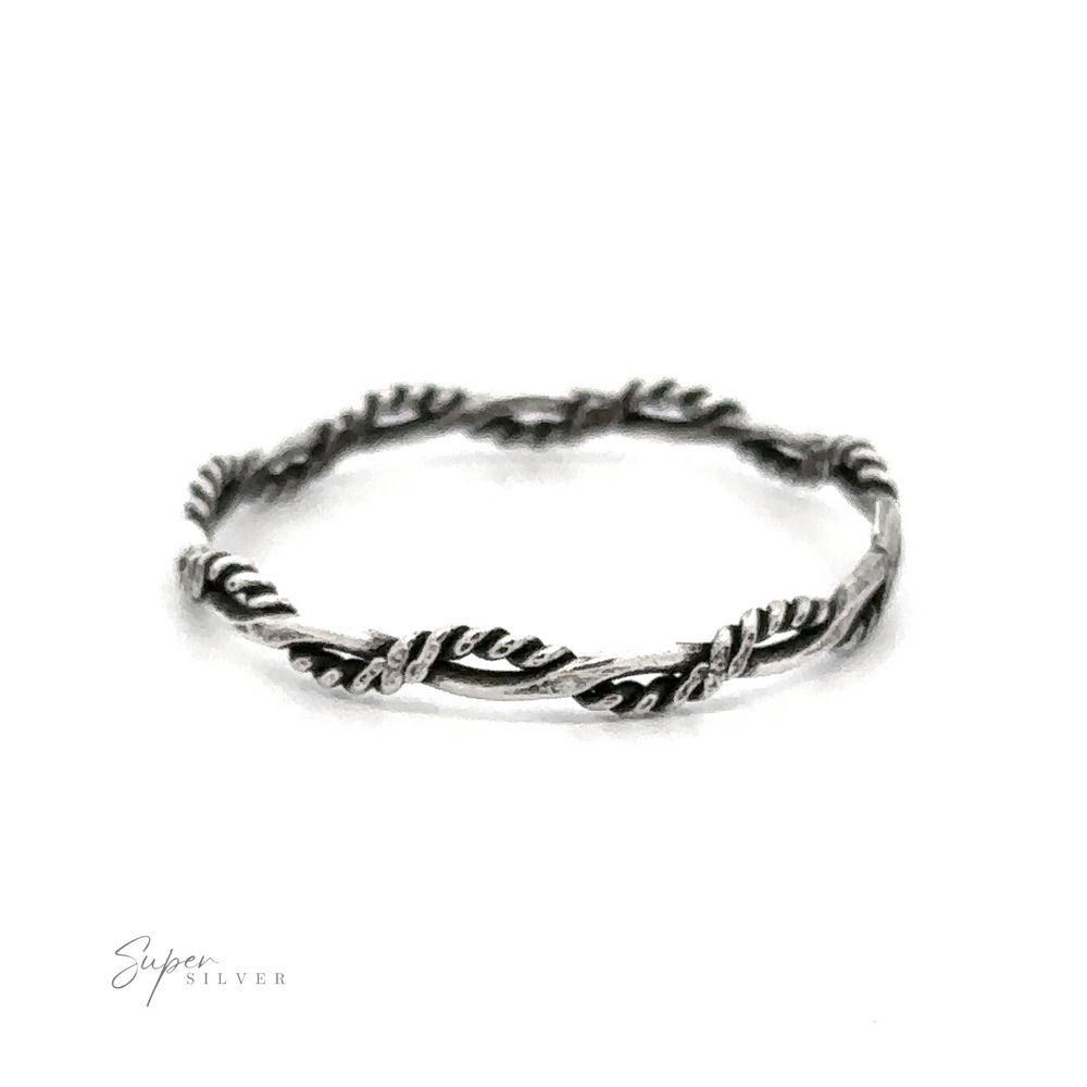 A teeny Tiny Twisted Rope Band ring with delicate bands and leaves on it.