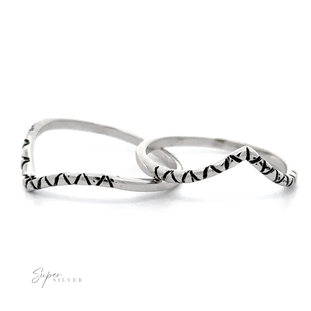 A pair of Patterned Chevron rings with intricate black and white designs.