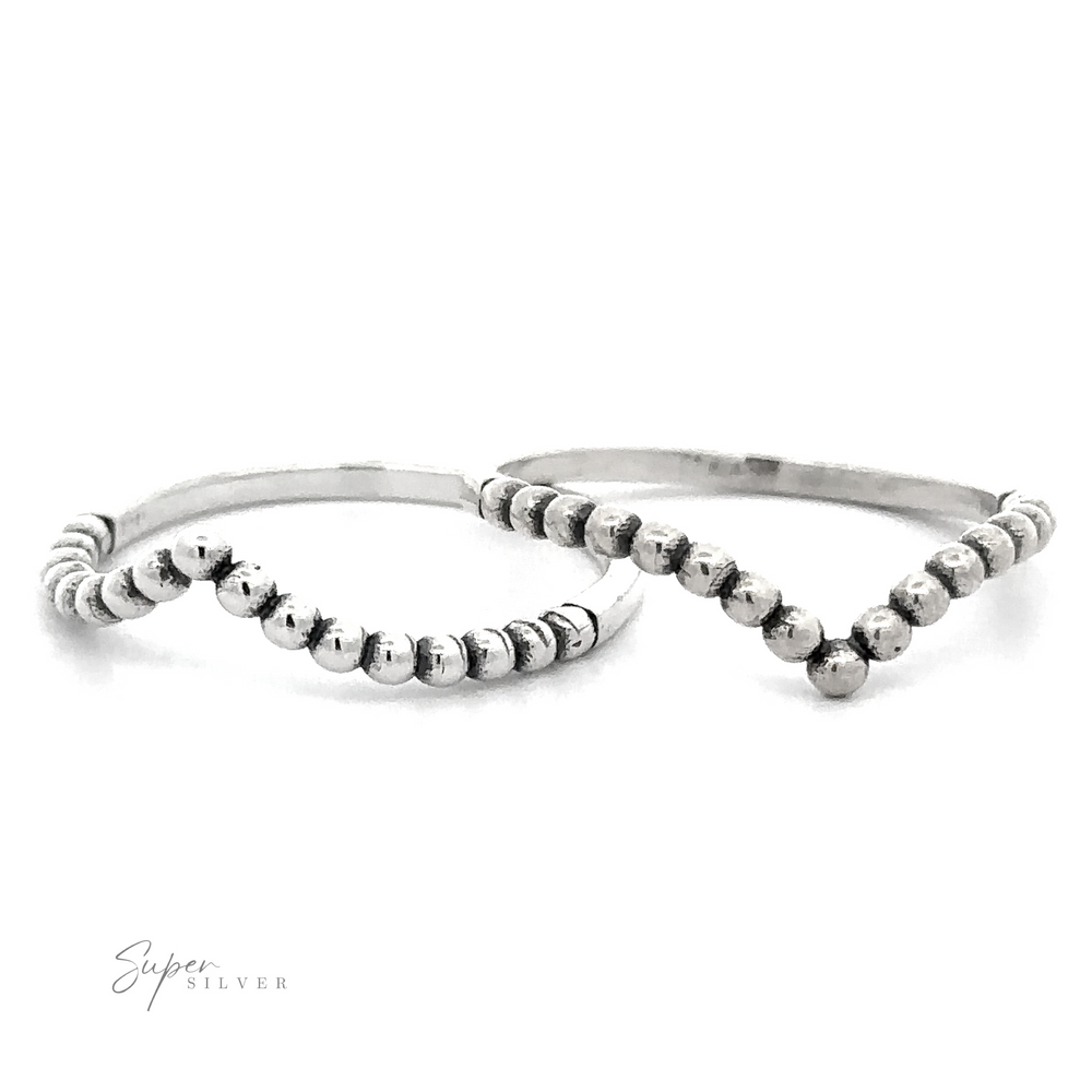 A pair of Beaded Chevron Rings in sterling silver with a chevron pattern.