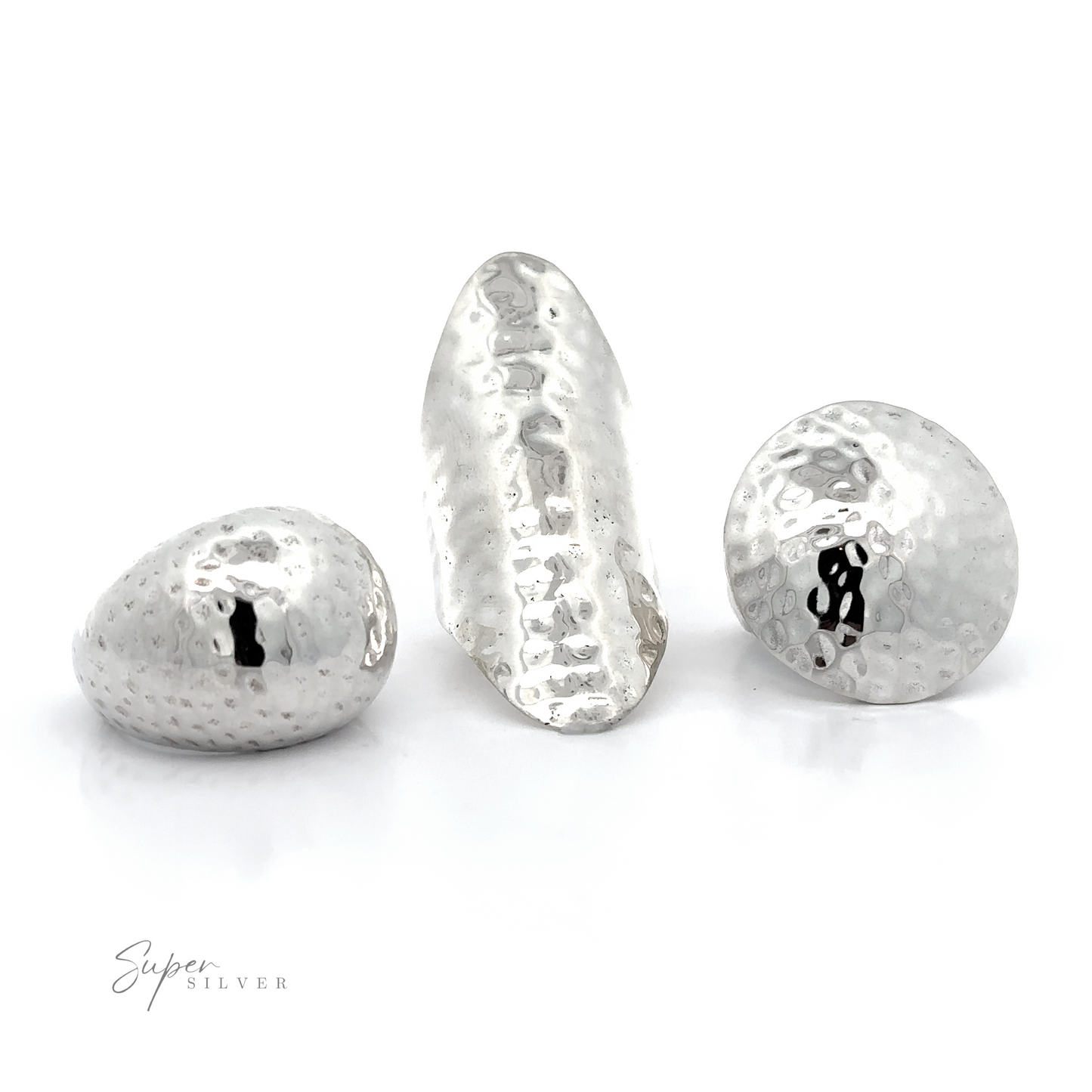 
                  
                    Three silver hammered beads on a white background, showcasing the boldness of the Statement Hammered Rings collection.
                  
                