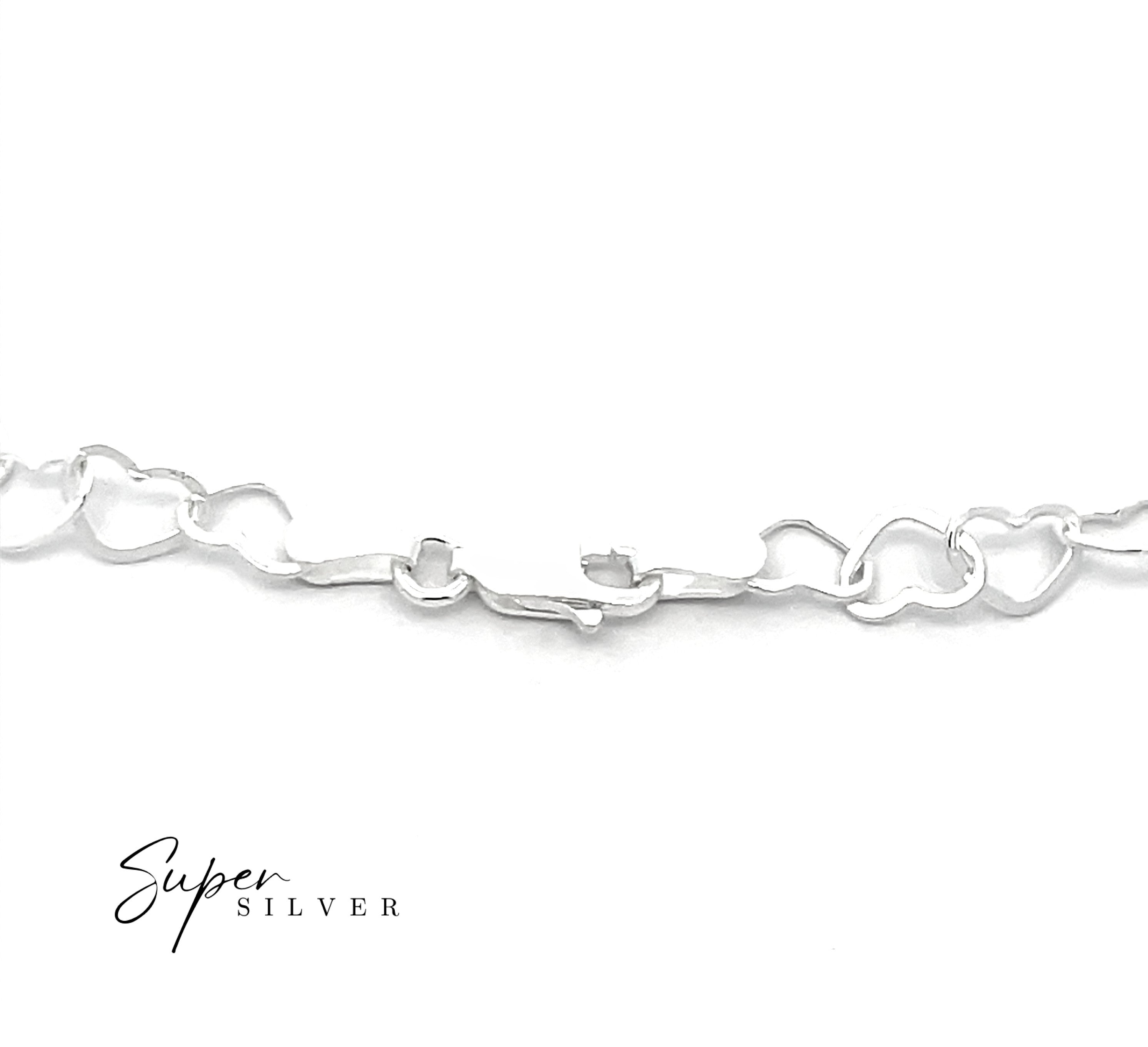 A close-up of the Italian Heart Link Chain featuring irregular heart-shaped links on a white background. "Super Silver" is displayed in the lower left corner.