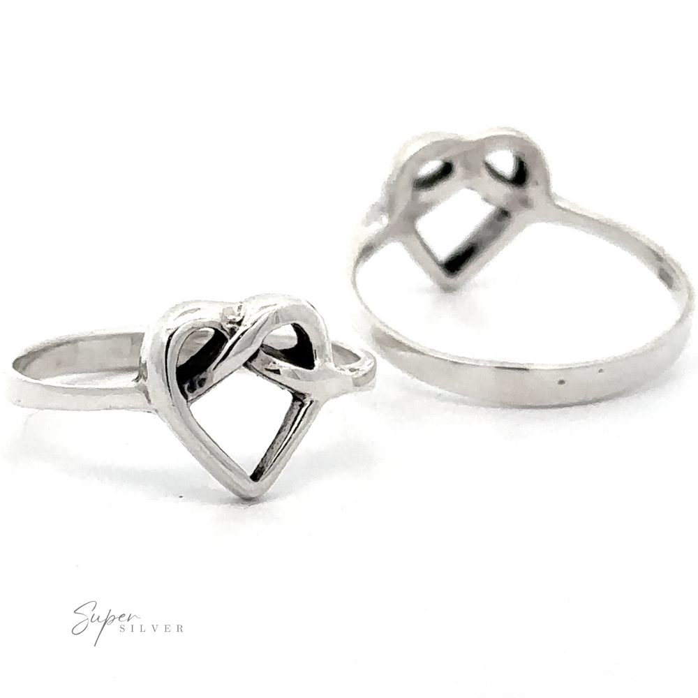 Two Entwined Heart Knot Rings on a white background, one ring in focus with overlapping hearts design and another slightly blurred in the background.