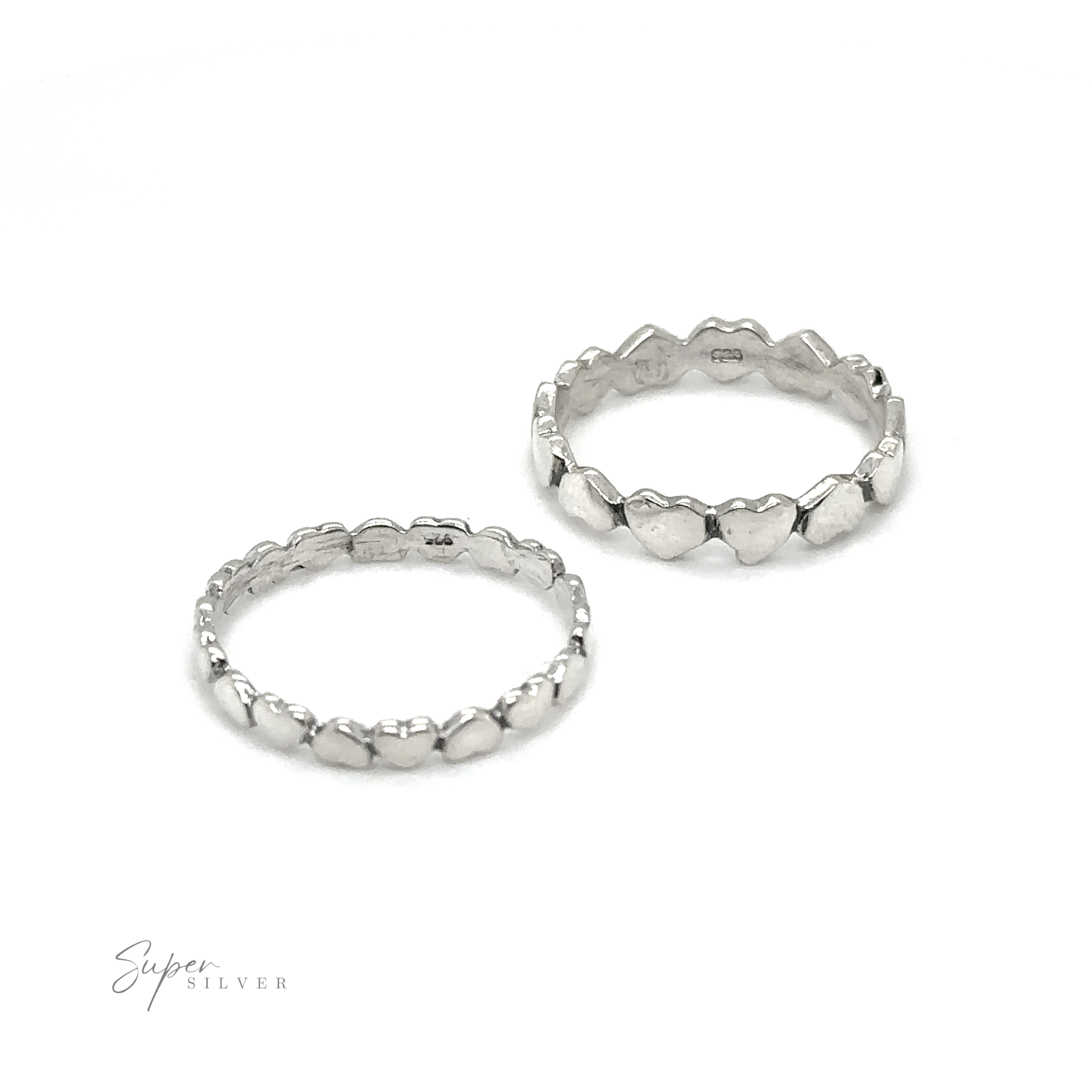 Two Hearts Band With Alternating Pattern stacking rings on a white background.