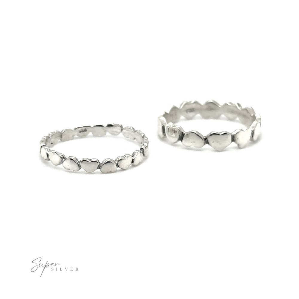 
                  
                    Two sterling silver rings with Hearts Band With Alternating Pattern, perfect for stacking.
                  
                