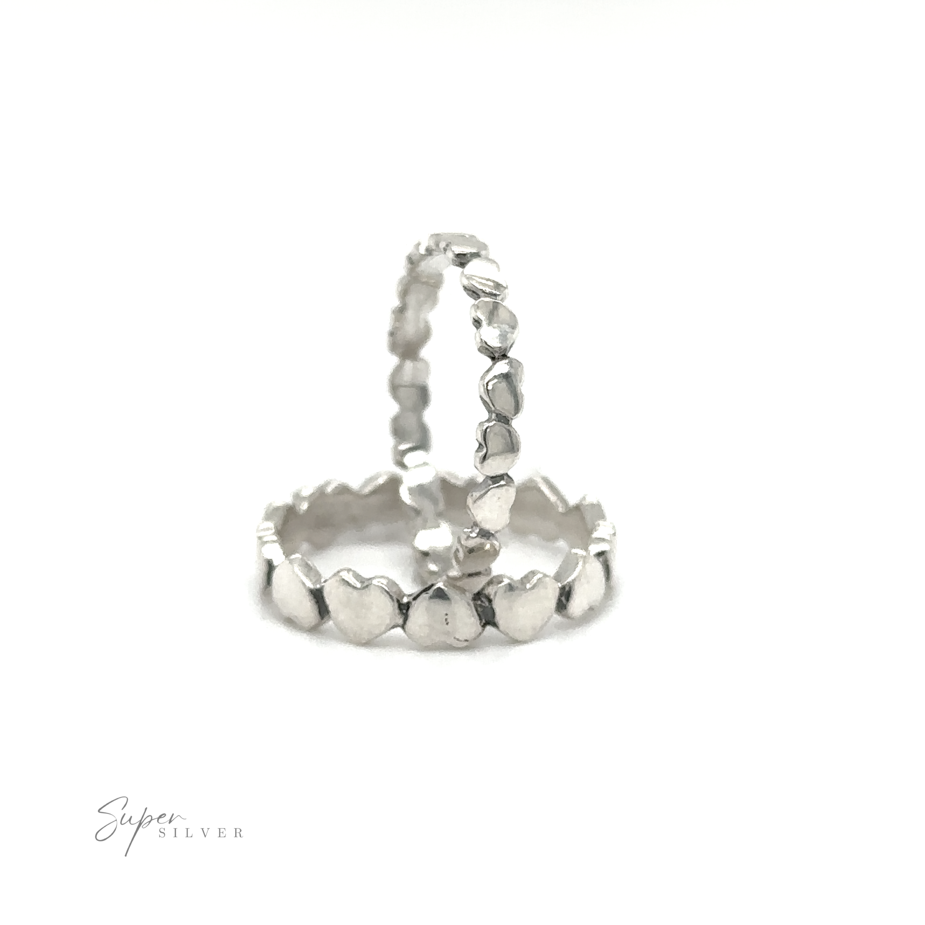 A pair of Hearts Band With Alternating Pattern stacking rings on a white background.